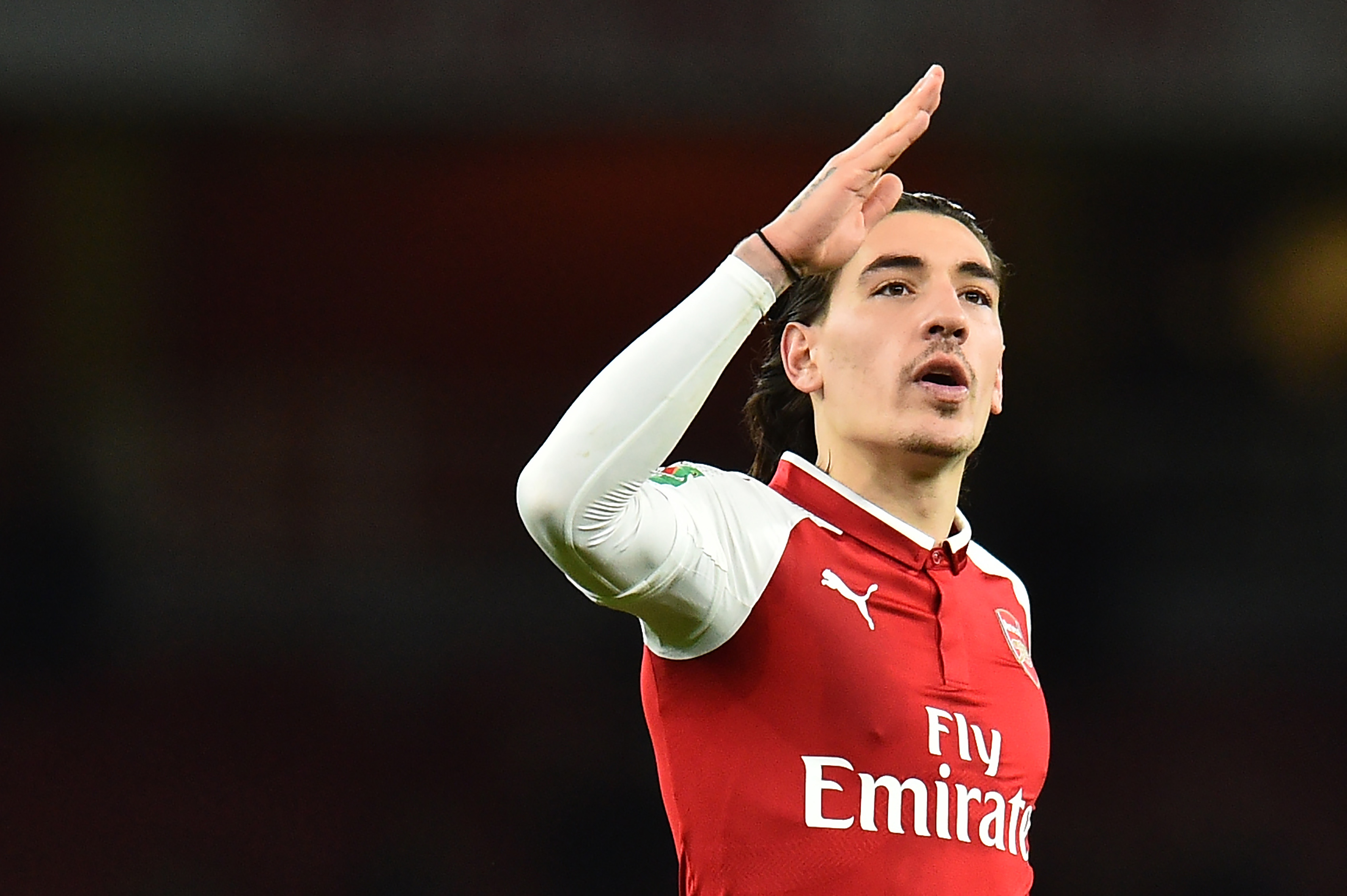 Arsenal's Spanish defender Hector Bellerin gestures at the final whistle during the League Cup semi-final football match between Arsenal and Chelsea at the Emirates Stadium in London on January 24, 2018.  / AFP PHOTO / Glyn KIRK / RESTRICTED TO EDITORIAL USE. No use with unauthorized audio, video, data, fixture lists, club/league logos or 'live' services. Online in-match use limited to 75 images, no video emulation. No use in betting, games or single club/league/player publications.  /         (Photo credit should read GLYN KIRK/AFP/Getty Images)