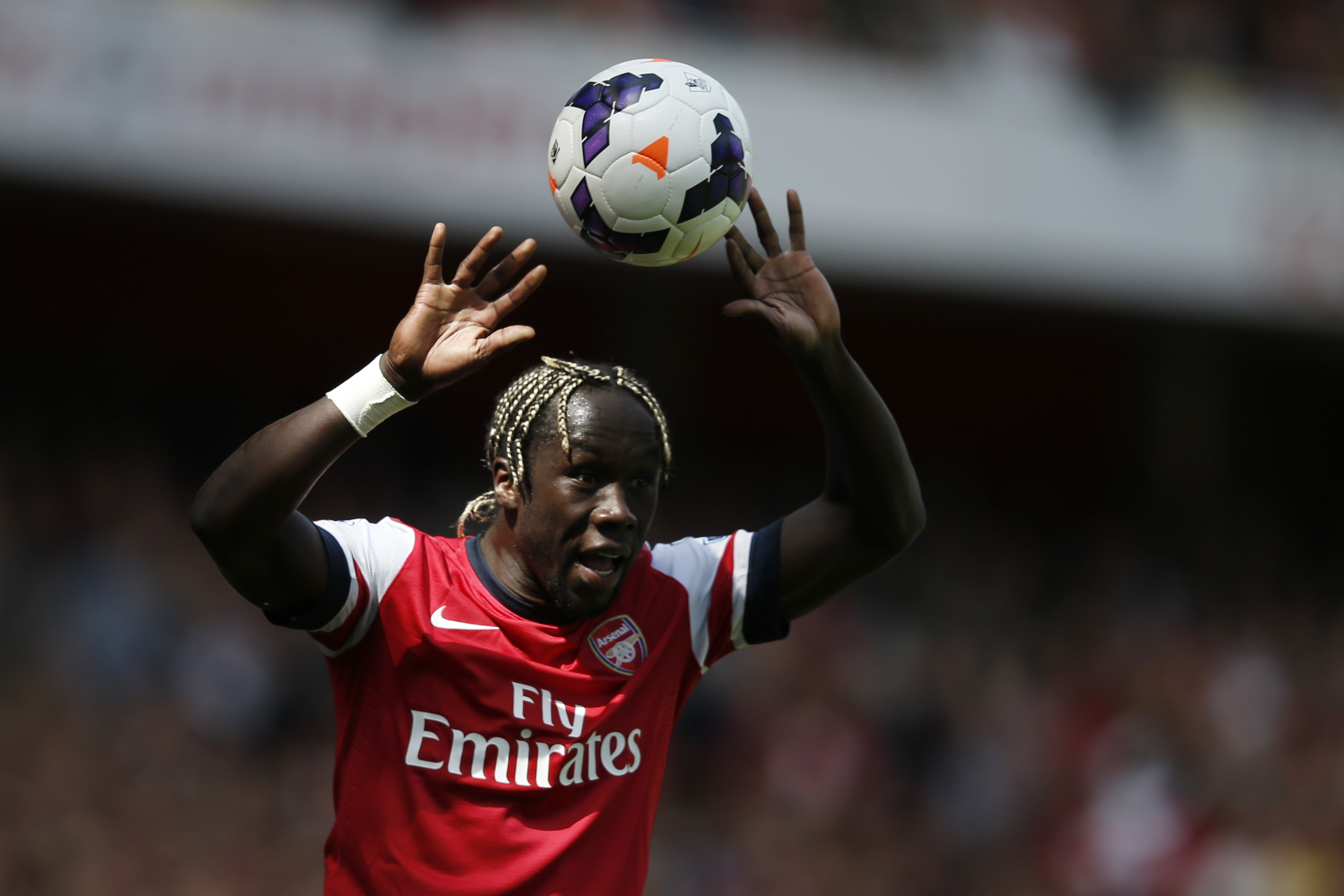 Arsenal's French defender Bacary Sagna takes a throw-in during the English Premier League football match between Arsenal and West Bromwich Albion at The Emirates Stadium in north London on May 4, 2014. AFP PHOTO / ADRIAN DENNIS

RESTRICTED TO EDITORIAL USE. No use with unauthorized audio, video, data, fixture lists, club/league logos or live services. Online in-match use limited to 45 images, no video emulation. No use in betting, games or single club/league/player publications.        (Photo credit should read ADRIAN DENNIS/AFP/Getty Images)