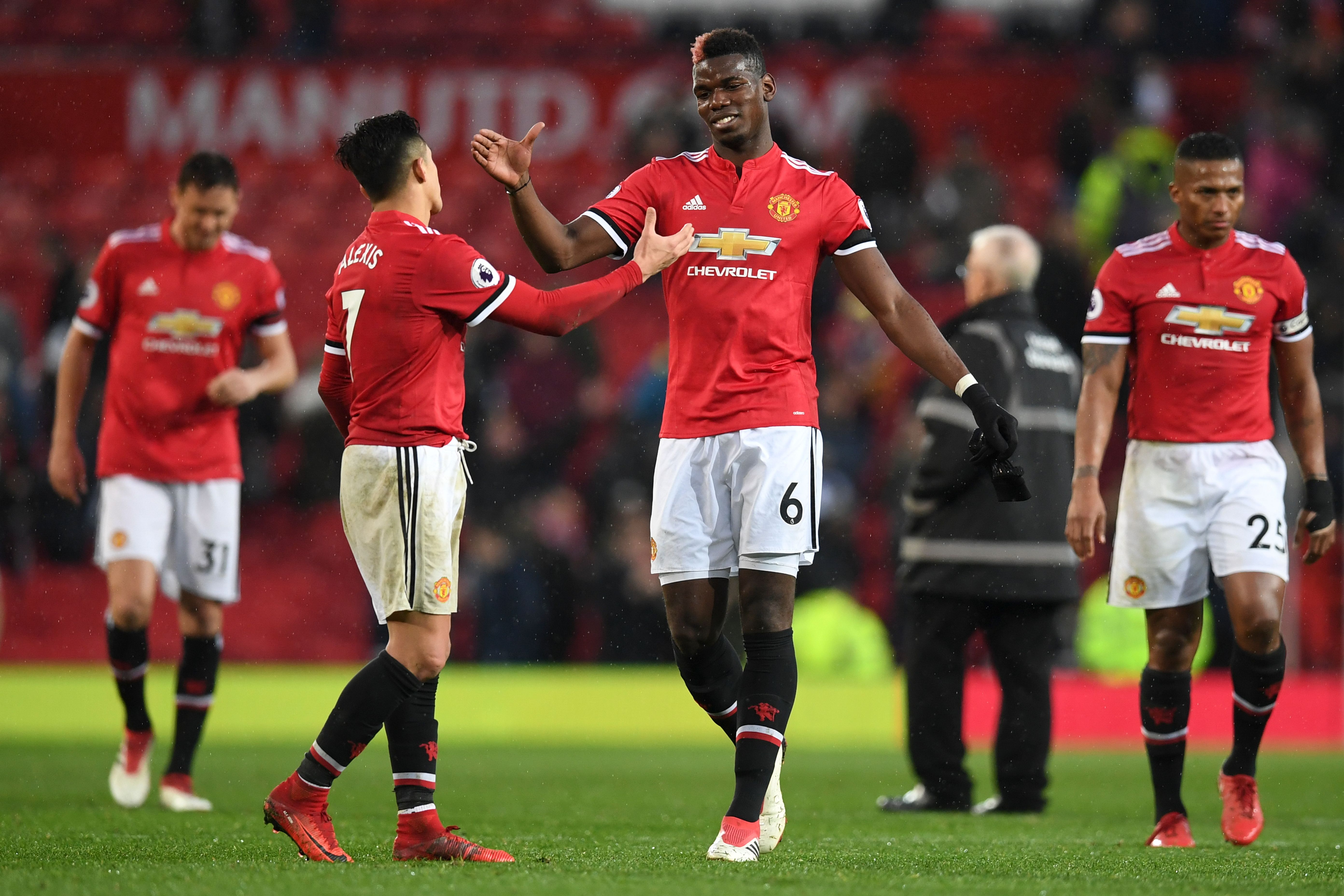 Manchester United's Chilean striker Alexis Sanchez (L) shakes hands with Manchester United's French midfielder Paul Pogba (R) at the end of the English Premier League football match between Manchester United and Huddersfield Town at Old Trafford in Manchester, north west England, on February 3, 2018. / AFP PHOTO / Paul ELLIS / RESTRICTED TO EDITORIAL USE. No use with unauthorized audio, video, data, fixture lists, club/league logos or 'live' services. Online in-match use limited to 75 images, no video emulation. No use in betting, games or single club/league/player publications.  /         (Photo credit should read PAUL ELLIS/AFP/Getty Images)