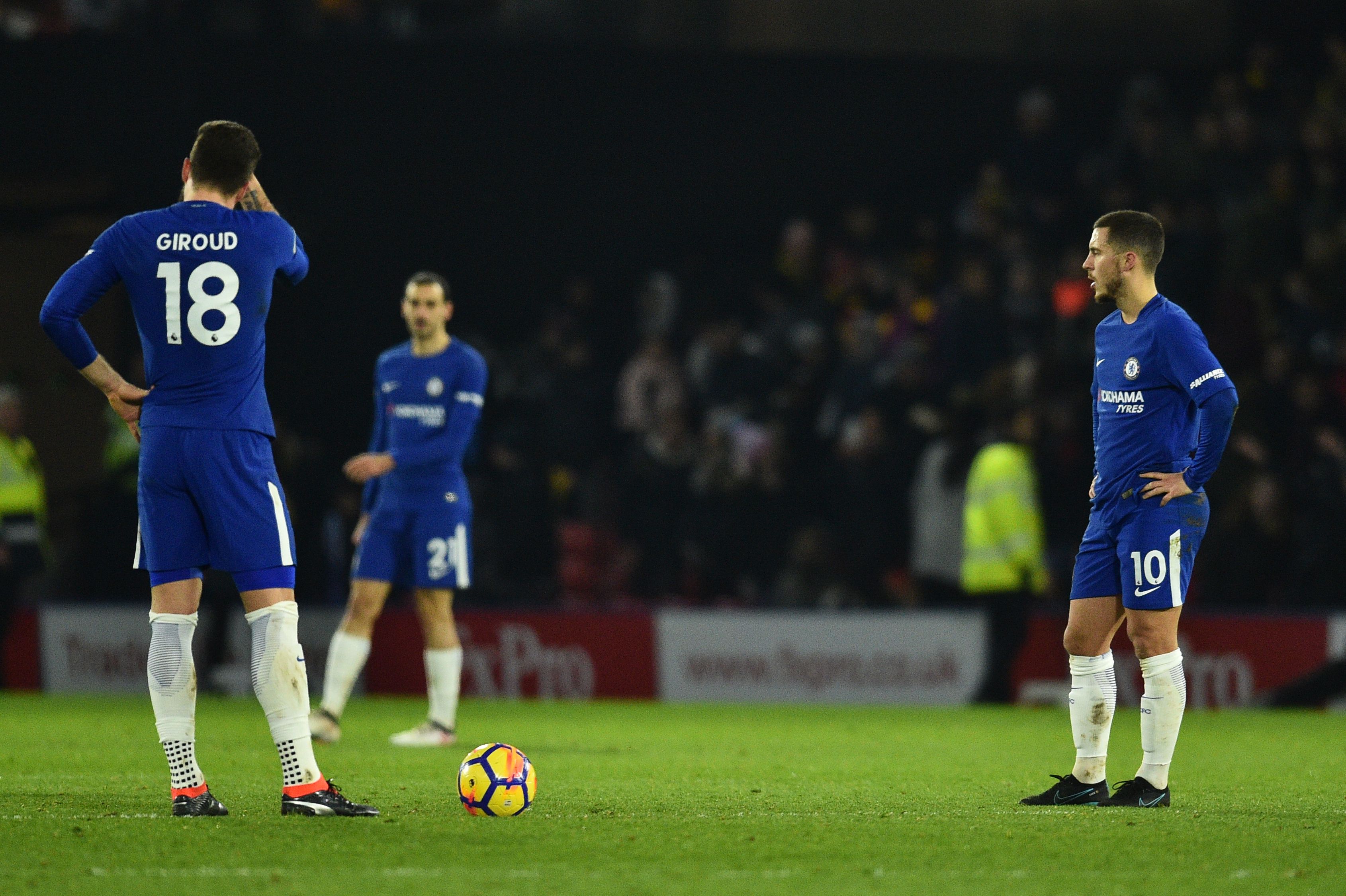 Chelsea's French attacker Olivier Giroud (L) and Chelsea's Belgian midfielder Eden Hazard react after Watford scored their third goal during the English Premier League football match between Watford and Chelsea at Vicarage Road Stadium in Watford, north of London on February 5, 2018. / AFP PHOTO / Glyn KIRK / RESTRICTED TO EDITORIAL USE. No use with unauthorized audio, video, data, fixture lists, club/league logos or 'live' services. Online in-match use limited to 75 images, no video emulation. No use in betting, games or single club/league/player publications.  /         (Photo credit should read GLYN KIRK/AFP/Getty Images)