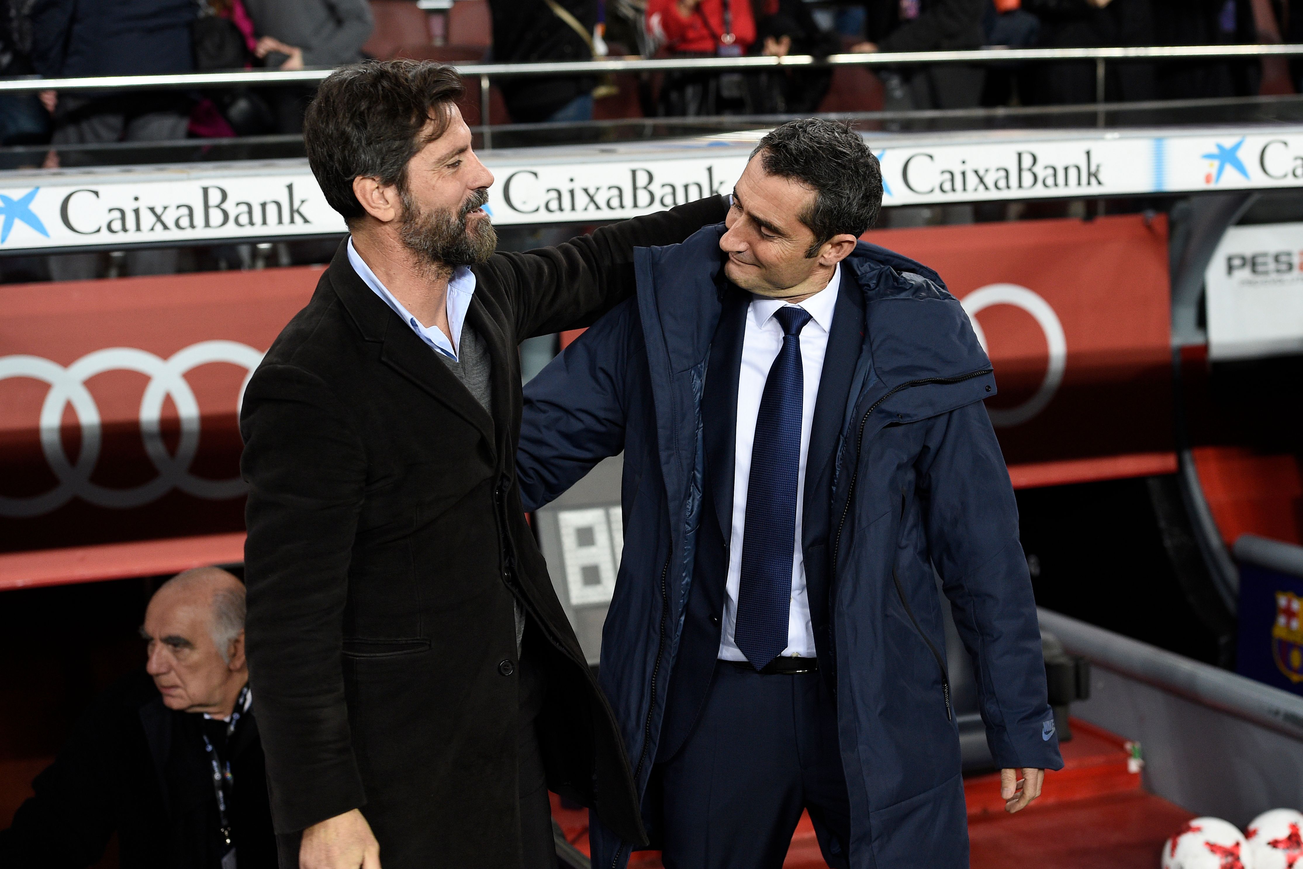 Barcelona's Spanish coach Ernesto Valverde (R) greets Espanyol's Spanish coach Quique Sanchez Flores ahead of the Spanish 'Copa del Rey' (King's cup) quarter-final second leg football match between FC Barcelona and RCD Espanyol at the Camp Nou stadium in Barcelona on January 25, 2018.  / AFP PHOTO / LLUIS GENE        (Photo credit should read LLUIS GENE/AFP/Getty Images)