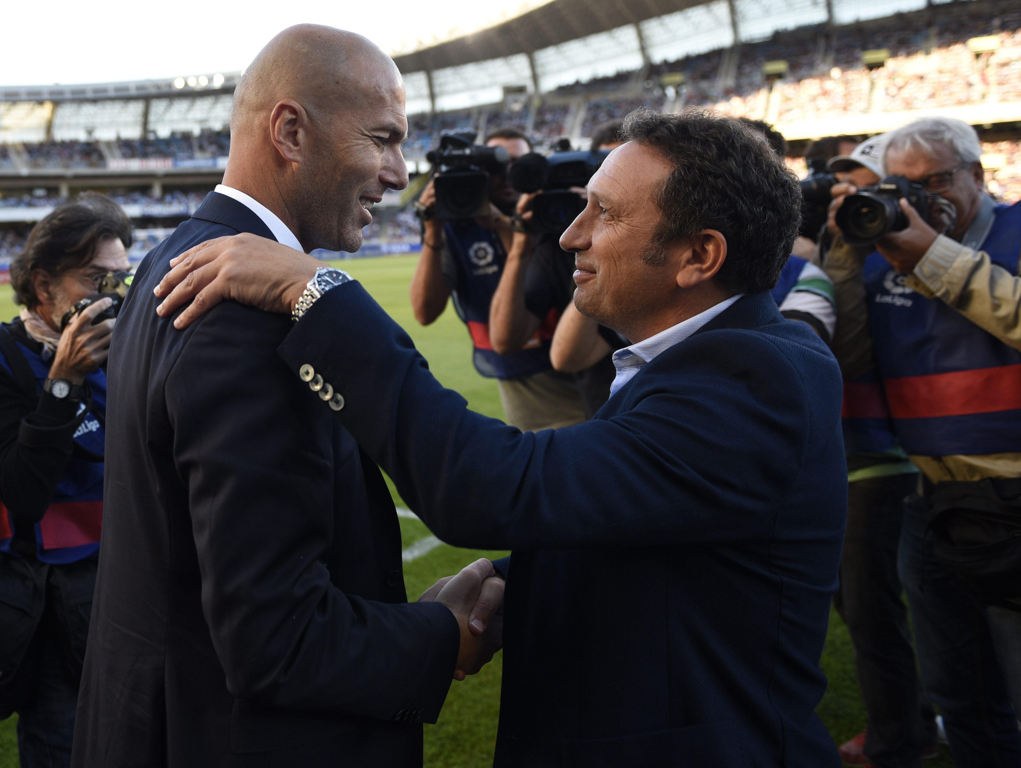 Real Madrid's French coach Zinedine Zidane (L) shakes hands with Real Sociedad's coach Eusebio Sacristan (R) before during the Spanish league football match Real Sociedad vs Real Madrid CF at the Anoeta stadium in San Sebastian on August 21, 2016. / AFP / ANDER GILLENEA        (Photo credit should read ANDER GILLENEA/AFP/Getty Images)