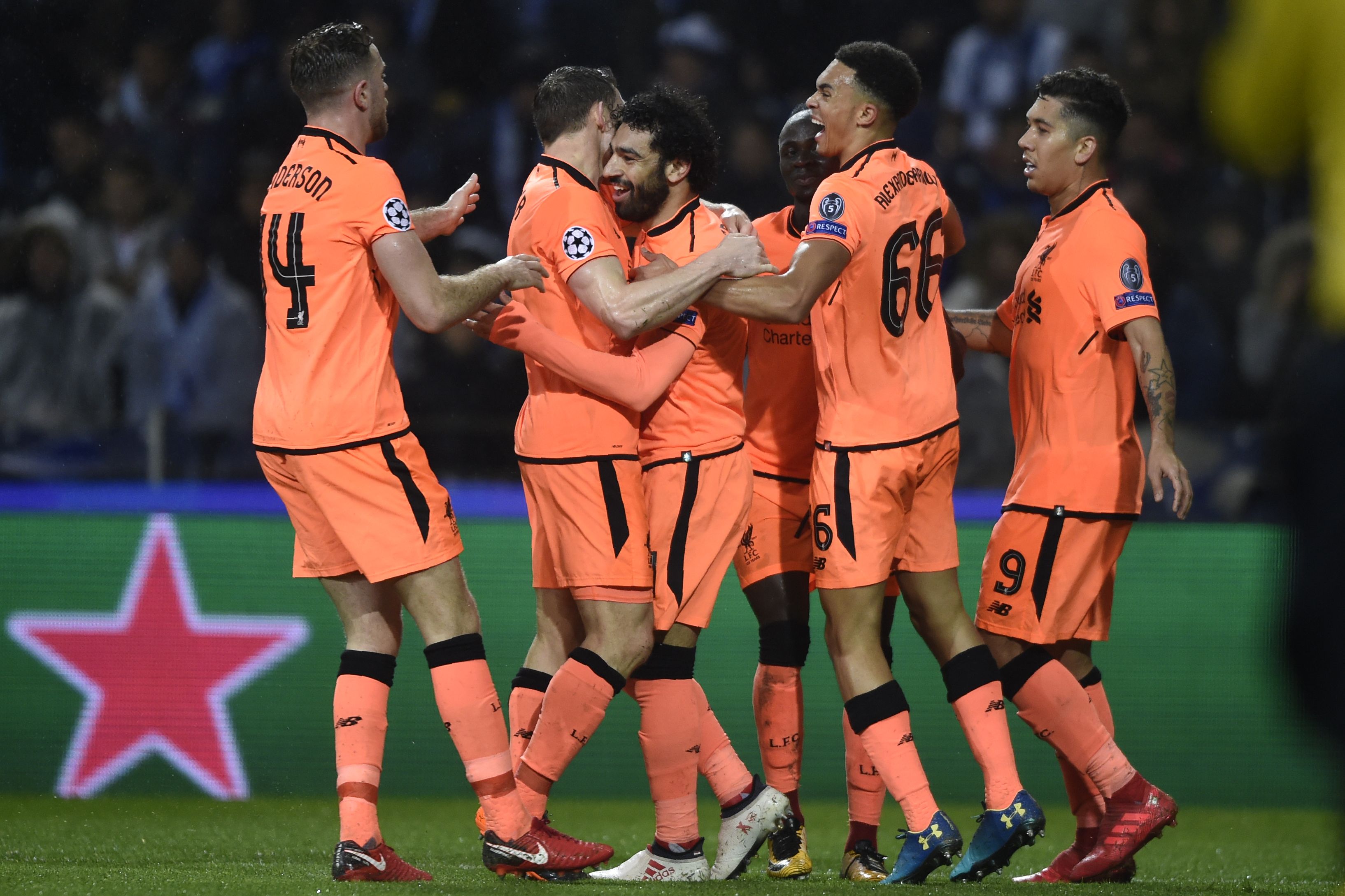 Liverpool's Egyptian midfielder Mohamed Salah (C) celebrates with teammates after scoring their second goal during the UEFA Champions League round of sixteen first leg football match between FC Porto and Liverpool at the Dragao stadium in Porto, Portugal on February 14, 2018. / AFP PHOTO / MIGUEL RIOPA        (Photo credit should read MIGUEL RIOPA/AFP/Getty Images)