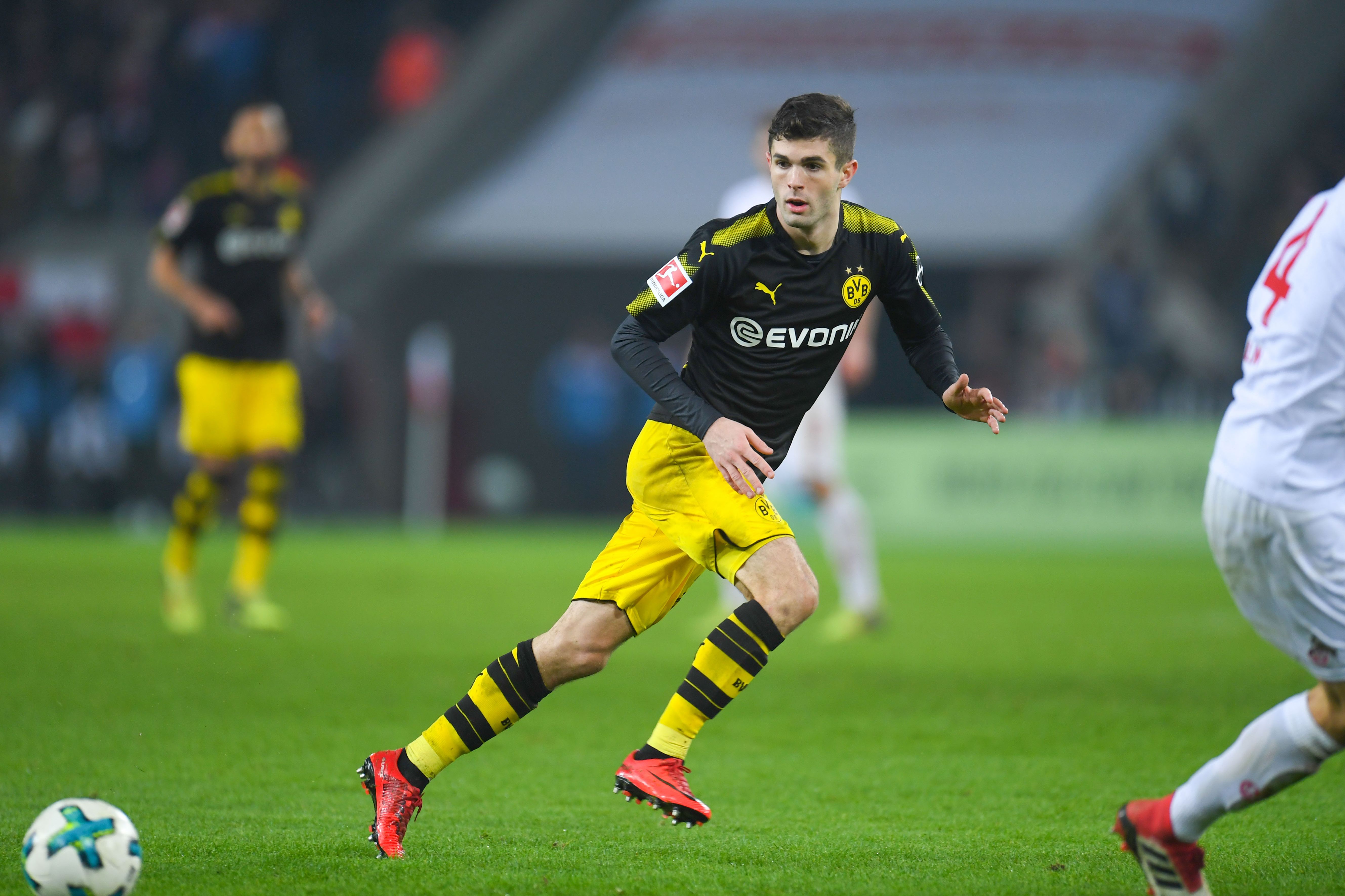 Dortmund's US midfielder Christian Pulisic vies for the ball during the German first division Bundesliga football match FC Cologne versus Borussia Dortmund in Cologne, western Germany, on February 2, 2018. / AFP PHOTO / Patrik STOLLARZ / RESTRICTIONS: DURING MATCH TIME: DFL RULES TO LIMIT THE ONLINE USAGE TO 15 PICTURES PER MATCH AND FORBID IMAGE SEQUENCES TO SIMULATE VIDEO. == RESTRICTED TO EDITORIAL USE == FOR FURTHER QUERIES PLEASE CONTACT DFL DIRECTLY AT + 49 69 650050
        (Photo credit should read PATRIK STOLLARZ/AFP/Getty Images)