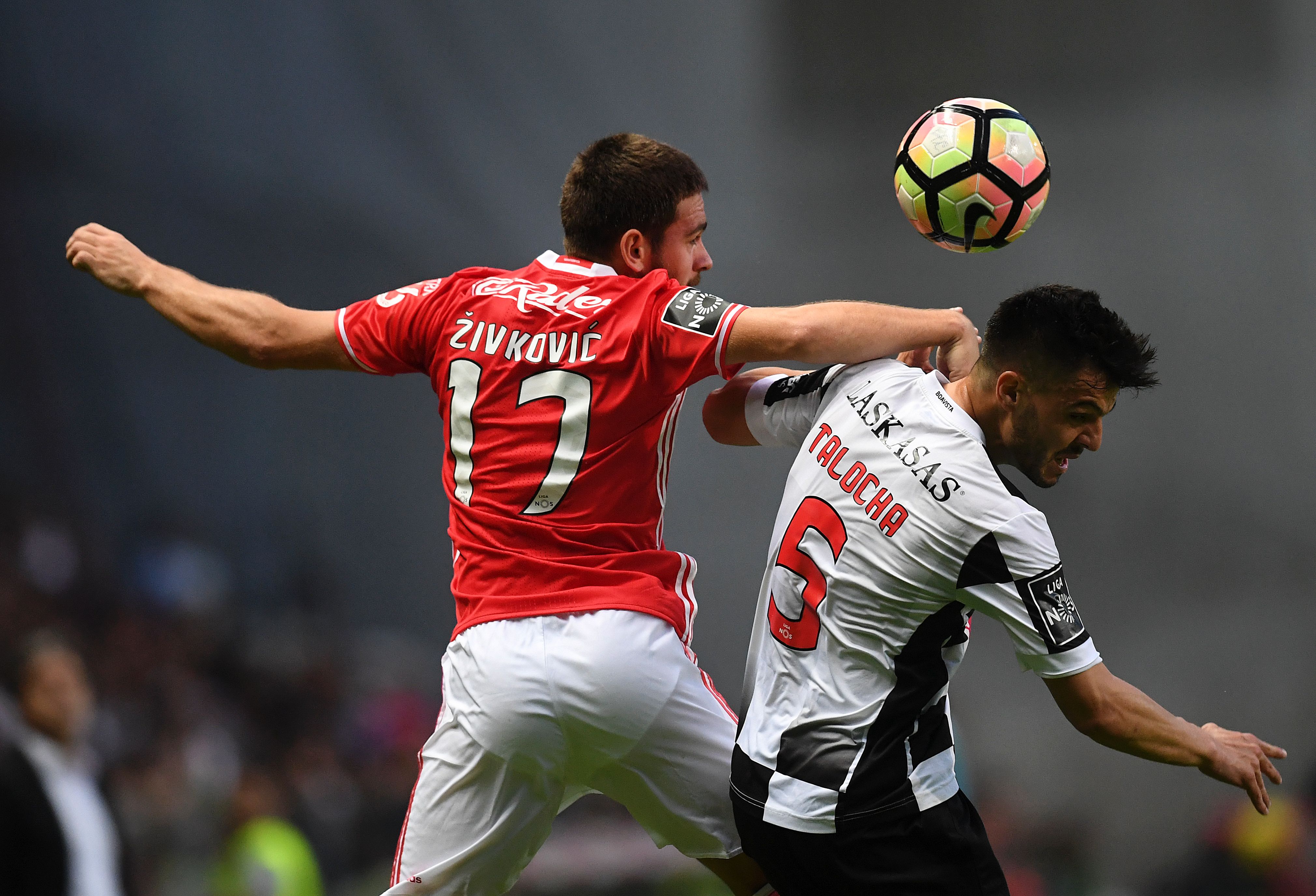 Benfica's Croatian forward Zivkovic (L) vies with Boavista's defender Talocha during the Portuguese league football match Boavista FC vs SL Benfica  at the Estadio do Bessa Seculo XXI in Porto on May 20, 2017. / AFP PHOTO / FRANCISCO LEONG        (Photo credit should read FRANCISCO LEONG/AFP/Getty Images)
