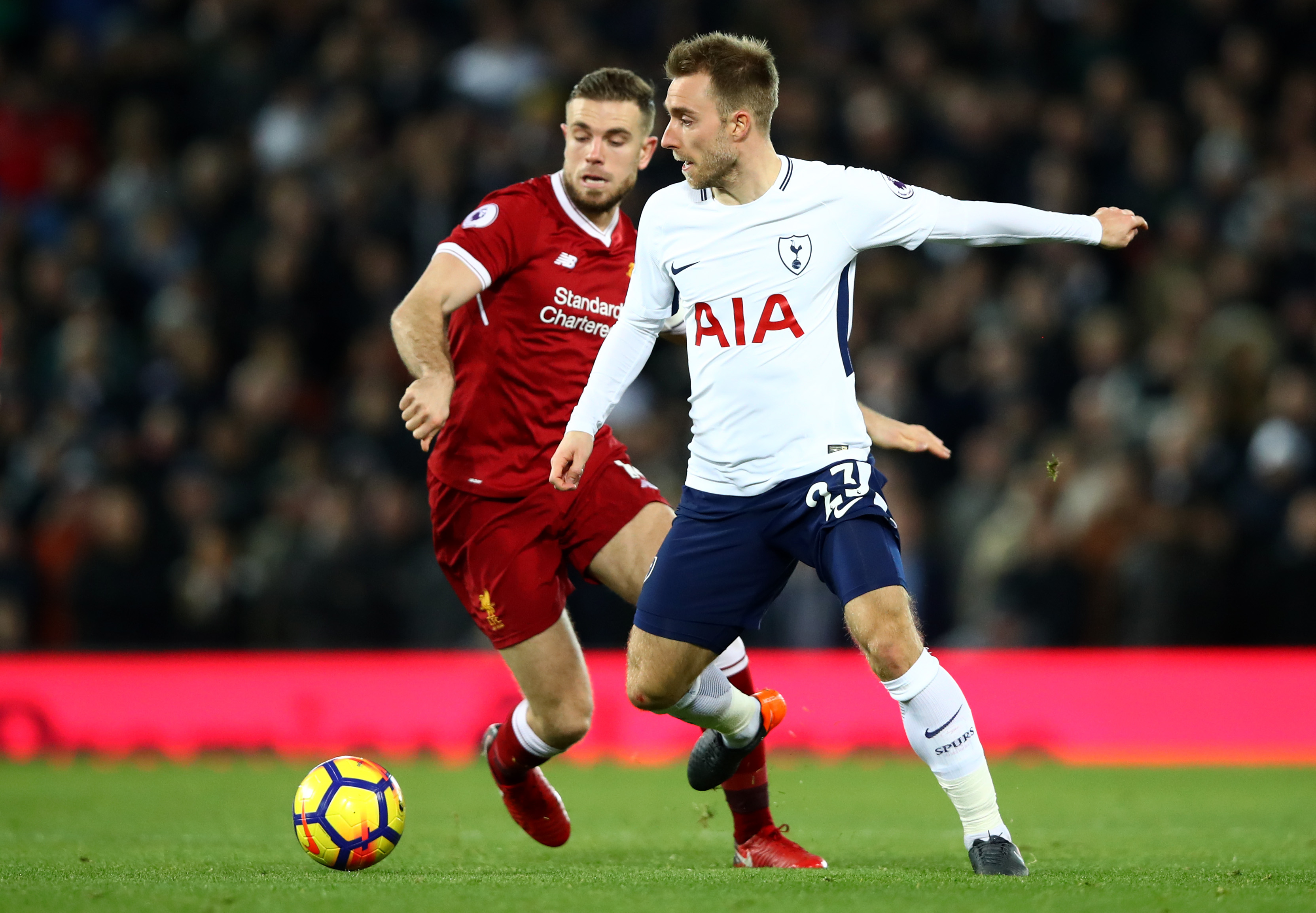 LIVERPOOL, ENGLAND - FEBRUARY 04:  Christian Eriksen of Tottenham Hotspur is challenged by  Jordan Henderson of Liverpool during the Premier League match between Liverpool and Tottenham Hotspur at Anfield on February 4, 2018 in Liverpool, England.  (Photo by Clive Brunskill/Getty Images)