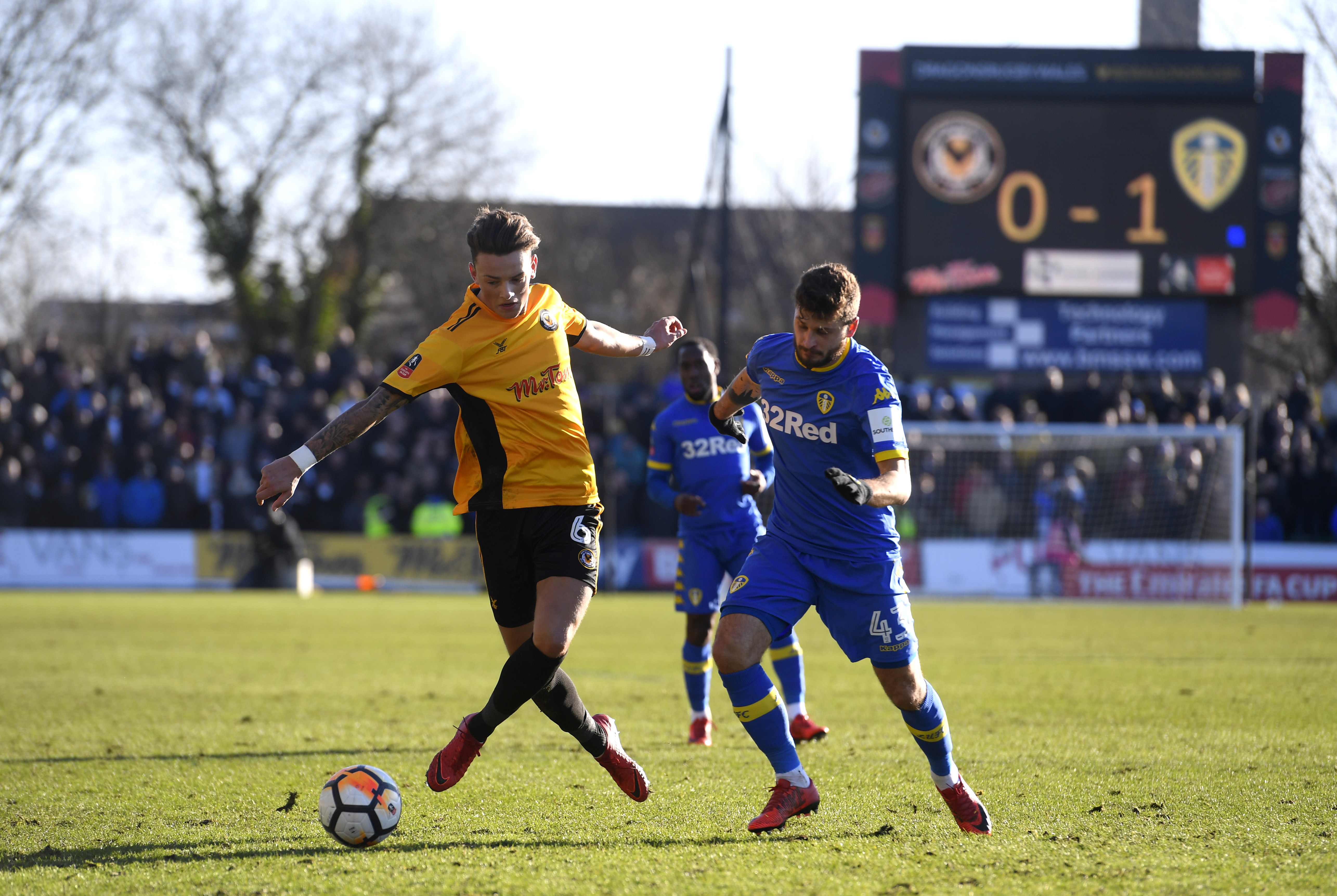 NEWPORT, WALES - JANUARY 07:  Ben White of Newport County and Mateusz Klich of Leeds United battle for the ball during The Emirates FA Cup Third Round match between Newport County and Leeds United at Rodney Parade on January 7, 2018 in Newport, Wales.  (Photo by Stu Forster/Getty Images)