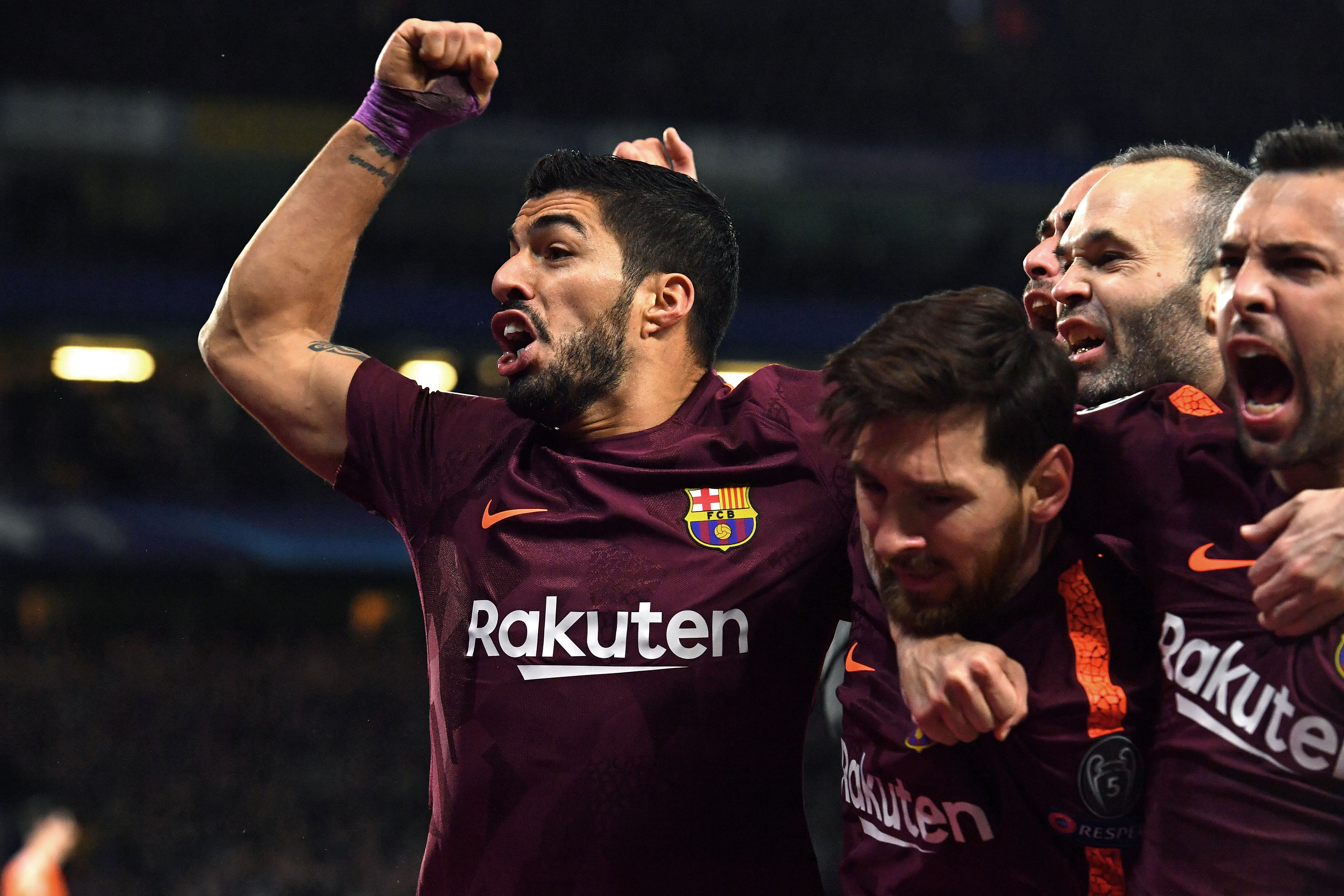 TOPSHOT - Barcelona's Argentinian striker Lionel Messi (C) celebrates with Barcelona's Uruguayan striker Luis Suarez (L) and teammates after scoring their first goal during the first leg of the UEFA Champions League round of 16 football match between Chelsea and Barcelona at Stamford Bridge stadium in London on February 20, 2018. / AFP PHOTO / Ben STANSALL        (Photo credit should read BEN STANSALL/AFP/Getty Images)