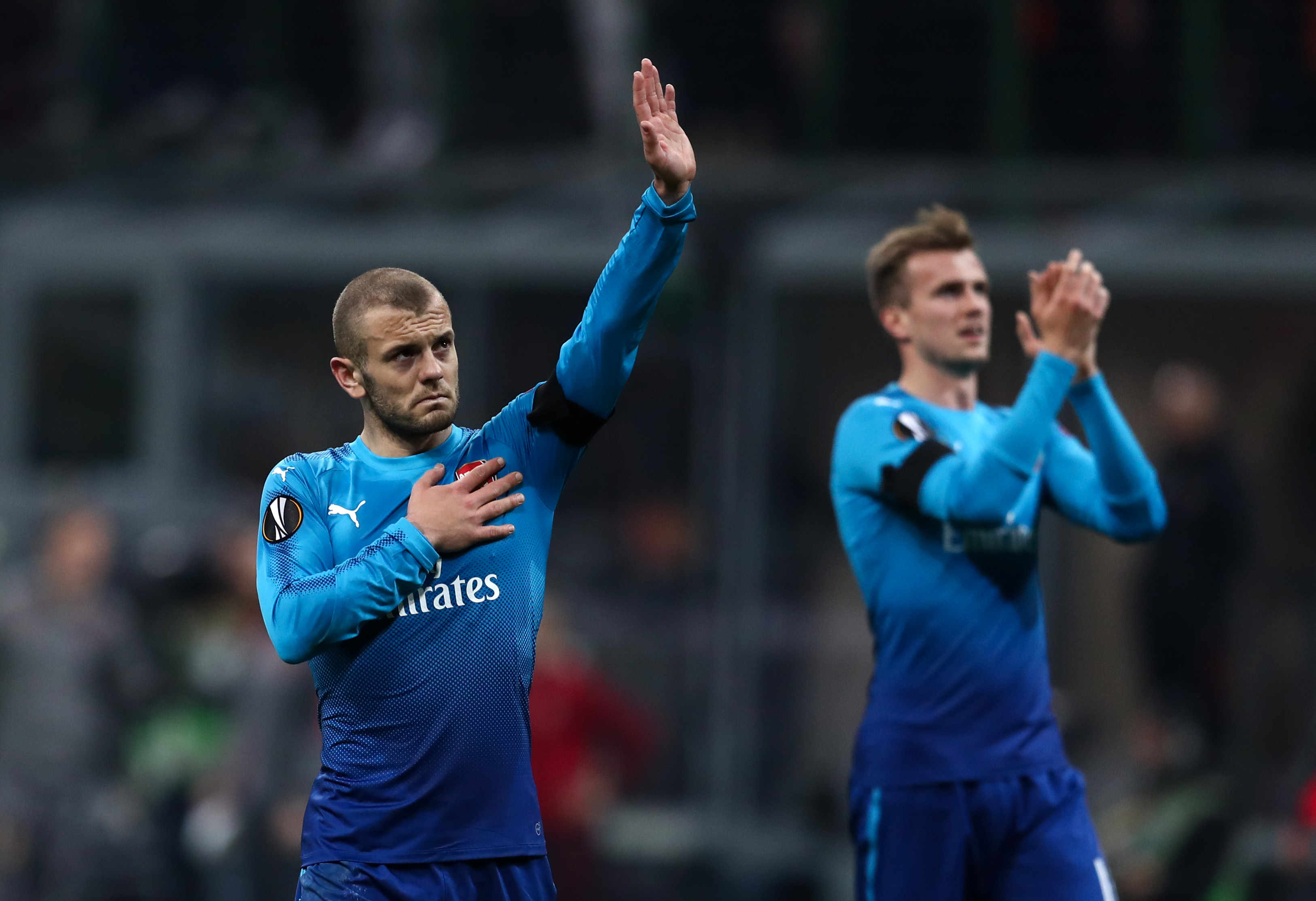 MILAN, ITALY - MARCH 08: Jack Wilshere of Arsenal pats the badge on his shirt after the UEFA Europa League Round of 16 match between AC Milan and Arsenal at the San Siro on March 8, 2018 in Milan, Italy. (Photo by Catherine Ivill/Getty Images)