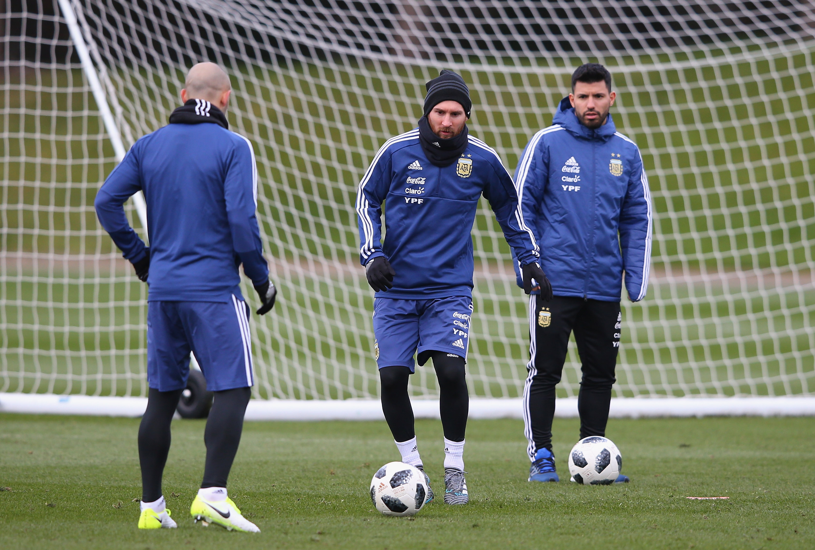 MANCHESTER, ENGLAND - MARCH 20:  Lionel Messi of Argentina controls the ball as Javier Mascherano and Sergio Aguero look on during a Argentina training session at Manchester City Football Academy on March 20, 2018 in Manchester, England.  (Photo by Alex Livesey/Getty Images)