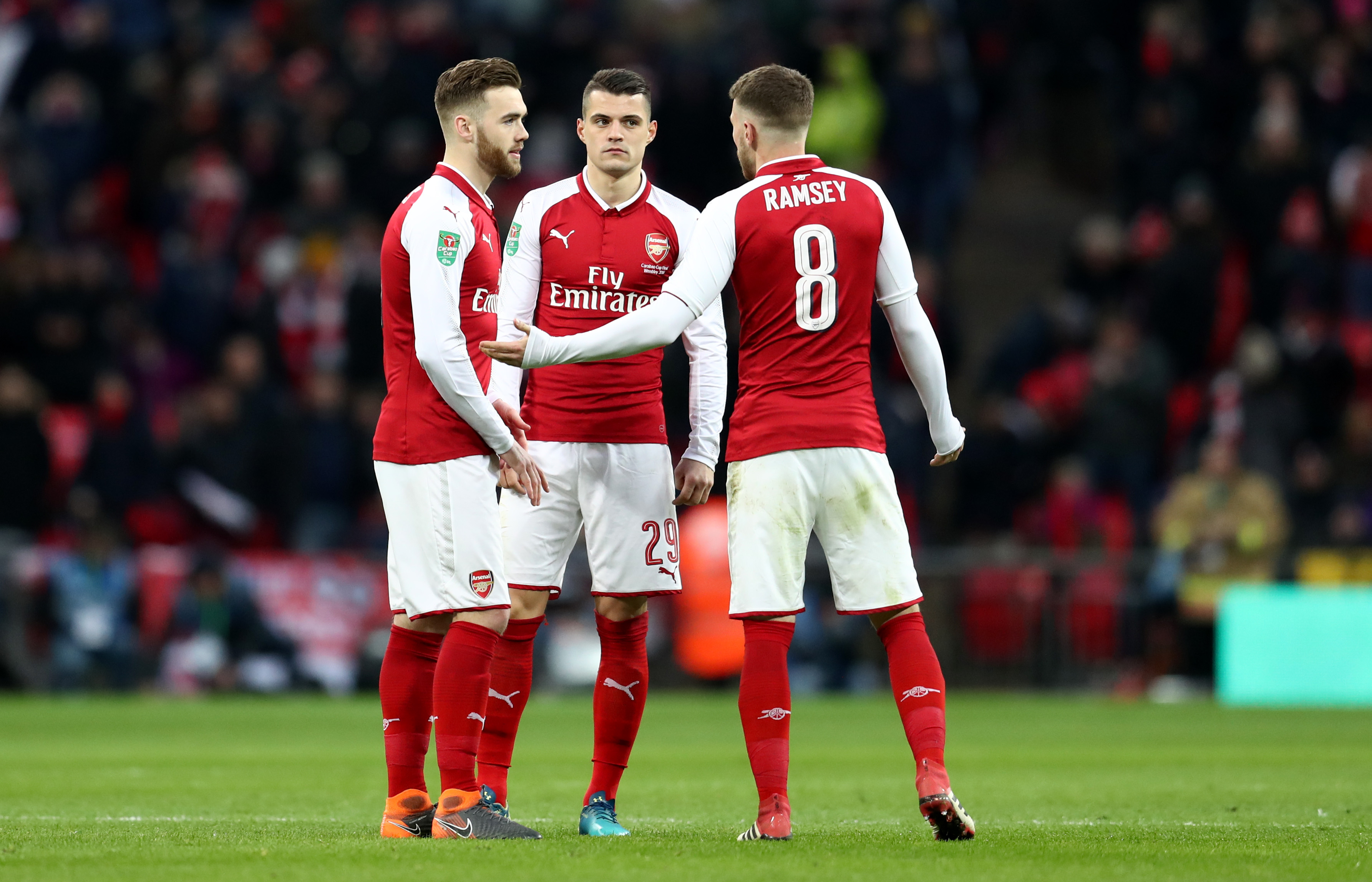 LONDON, ENGLAND - FEBRUARY 25: Aaron Ramsey of Arsenal talks to Calum Chambers and Granit Xhaka of Arsenal during the Carabao Cup Final between Arsenal and Manchester City at Wembley Stadium on February 25, 2018 in London, England. (Photo by Catherine Ivill/Getty Images)