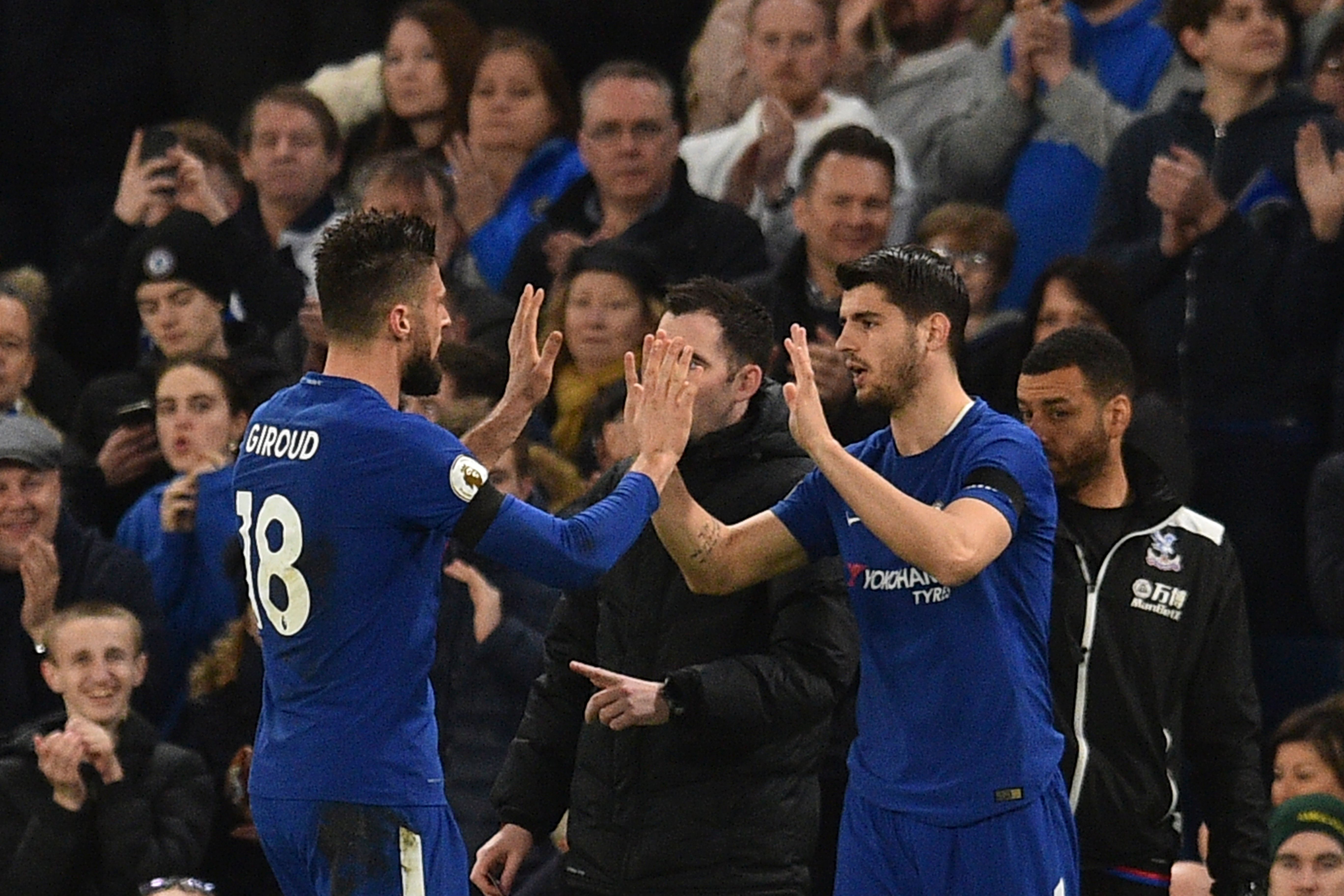 Chelsea's French attacker Olivier Giroud (L) high-fives his replacement Chelsea's Spanish striker Alvaro Morata (R) as he goes off as a substitute during the English Premier League football match between Chelsea and Crystal Palace at Stamford Bridge in London on March 10, 2018. / AFP PHOTO / Glyn KIRK / RESTRICTED TO EDITORIAL USE. No use with unauthorized audio, video, data, fixture lists, club/league logos or 'live' services. Online in-match use limited to 75 images, no video emulation. No use in betting, games or single club/league/player publications.  /         (Photo credit should read GLYN KIRK/AFP/Getty Images)