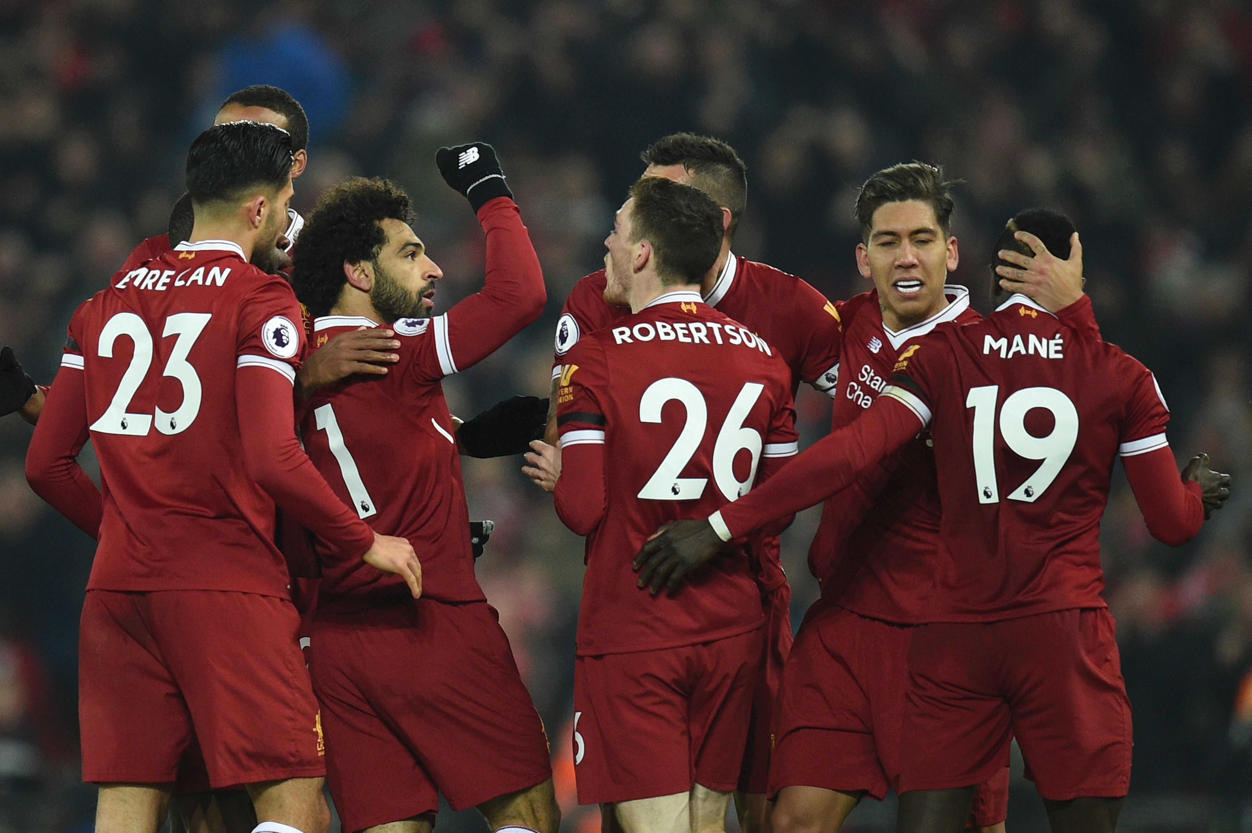 Liverpool's Egyptian midfielder Mohamed Salah (2L) celebrates scoring their fourth goal to make the score 4-1 with team-mates including goalscorers Liverpool's Senegalese midfielder Sadio Mane (R) and Liverpool's Brazilian midfielder Roberto Firmino (2R) during the English Premier League football match between Liverpool and Manchester City at Anfield in Liverpool, north west England on January 14, 2018. / AFP PHOTO / Oli SCARFF / RESTRICTED TO EDITORIAL USE. No use with unauthorized audio, video, data, fixture lists, club/league logos or 'live' services. Online in-match use limited to 75 images, no video emulation. No use in betting, games or single club/league/player publications.  /         (Photo credit should read OLI SCARFF/AFP/Getty Images)