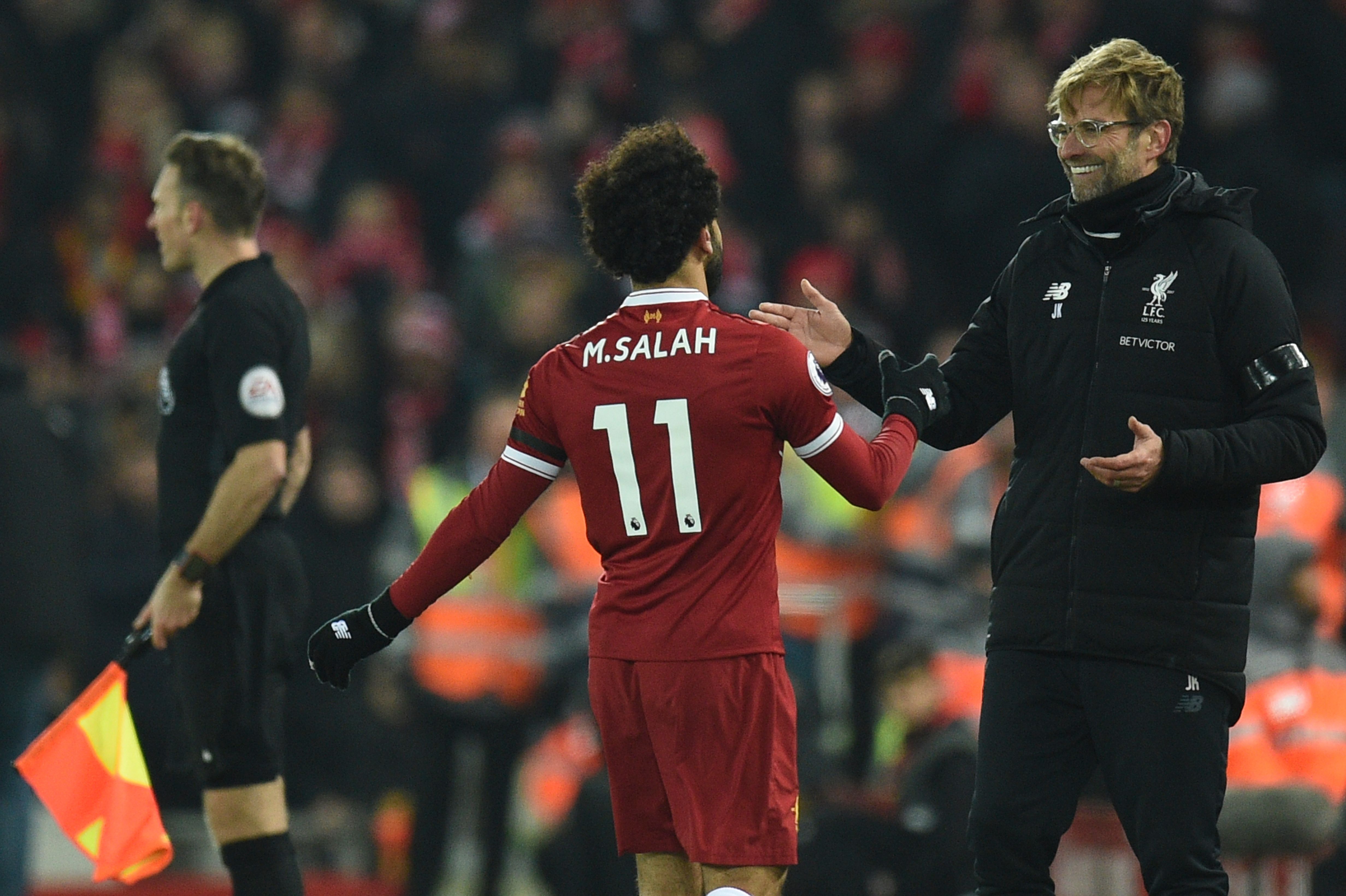Liverpool's German manager Jurgen Klopp (R) greets Liverpool's Egyptian midfielder Mohamed Salah (L) as Salah comes off during the English Premier League football match between Liverpool and Manchester City at Anfield in Liverpool, north west England on January 14, 2018. / AFP PHOTO / Oli SCARFF / RESTRICTED TO EDITORIAL USE. No use with unauthorized audio, video, data, fixture lists, club/league logos or 'live' services. Online in-match use limited to 75 images, no video emulation. No use in betting, games or single club/league/player publications.  /         (Photo credit should read OLI SCARFF/AFP/Getty Images)