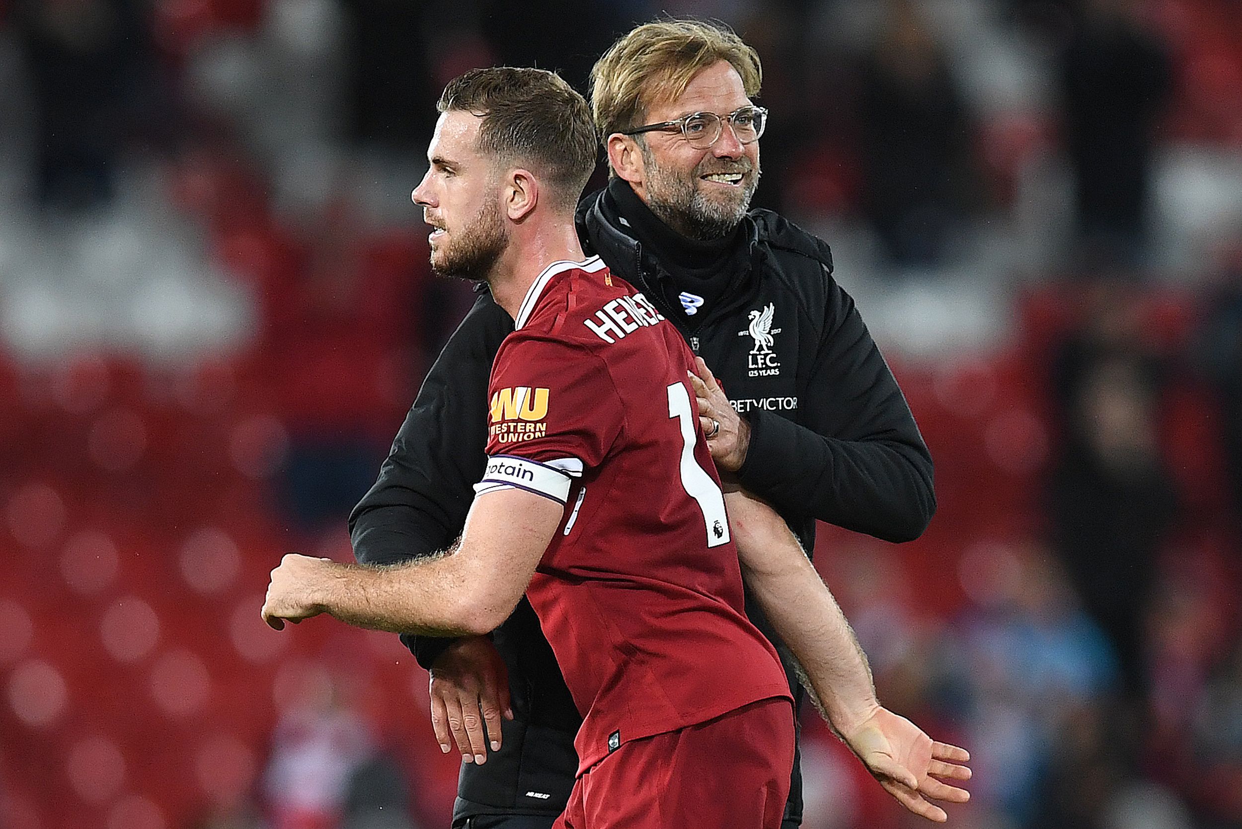 Liverpool's German manager Jurgen Klopp hugs Liverpool's English midfielder Jordan Henderson following the English Premier League football match between Liverpool and Southampton at Anfield in Liverpool, north west England on November 18, 2017. / AFP PHOTO / Paul ELLIS / RESTRICTED TO EDITORIAL USE. No use with unauthorized audio, video, data, fixture lists, club/league logos or 'live' services. Online in-match use limited to 75 images, no video emulation. No use in betting, games or single club/league/player publications.  /         (Photo credit should read PAUL ELLIS/AFP/Getty Images)