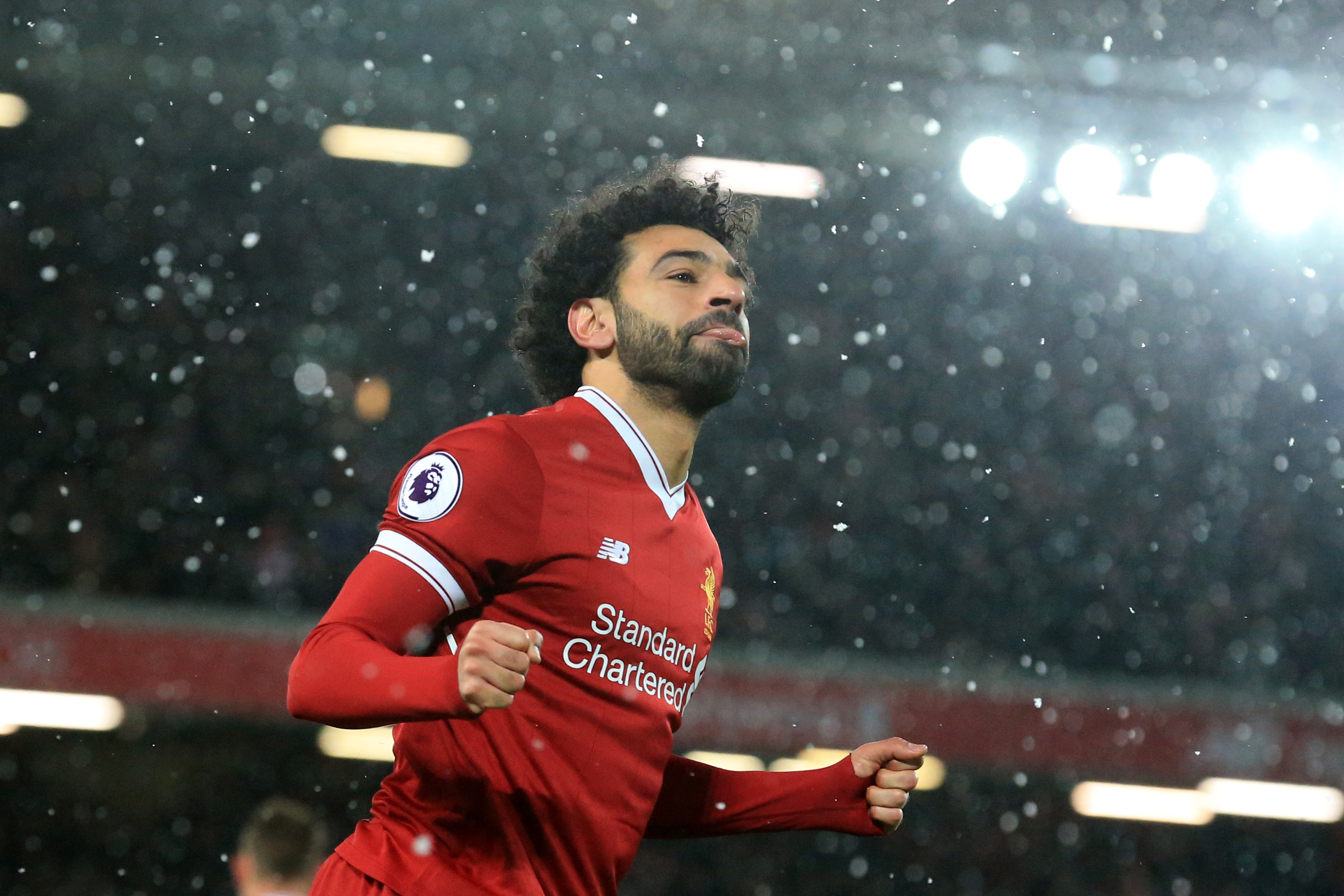 Liverpool's Egyptian midfielder Mohamed Salah celebrates scoring the team's fourth goal during the English Premier League football match between Liverpool and Watford at Anfield in Liverpool, north west England on March 17, 2018. / AFP PHOTO / Lindsey PARNABY / RESTRICTED TO EDITORIAL USE. No use with unauthorized audio, video, data, fixture lists, club/league logos or 'live' services. Online in-match use limited to 75 images, no video emulation. No use in betting, games or single club/league/player publications.  /         (Photo credit should read LINDSEY PARNABY/AFP/Getty Images)