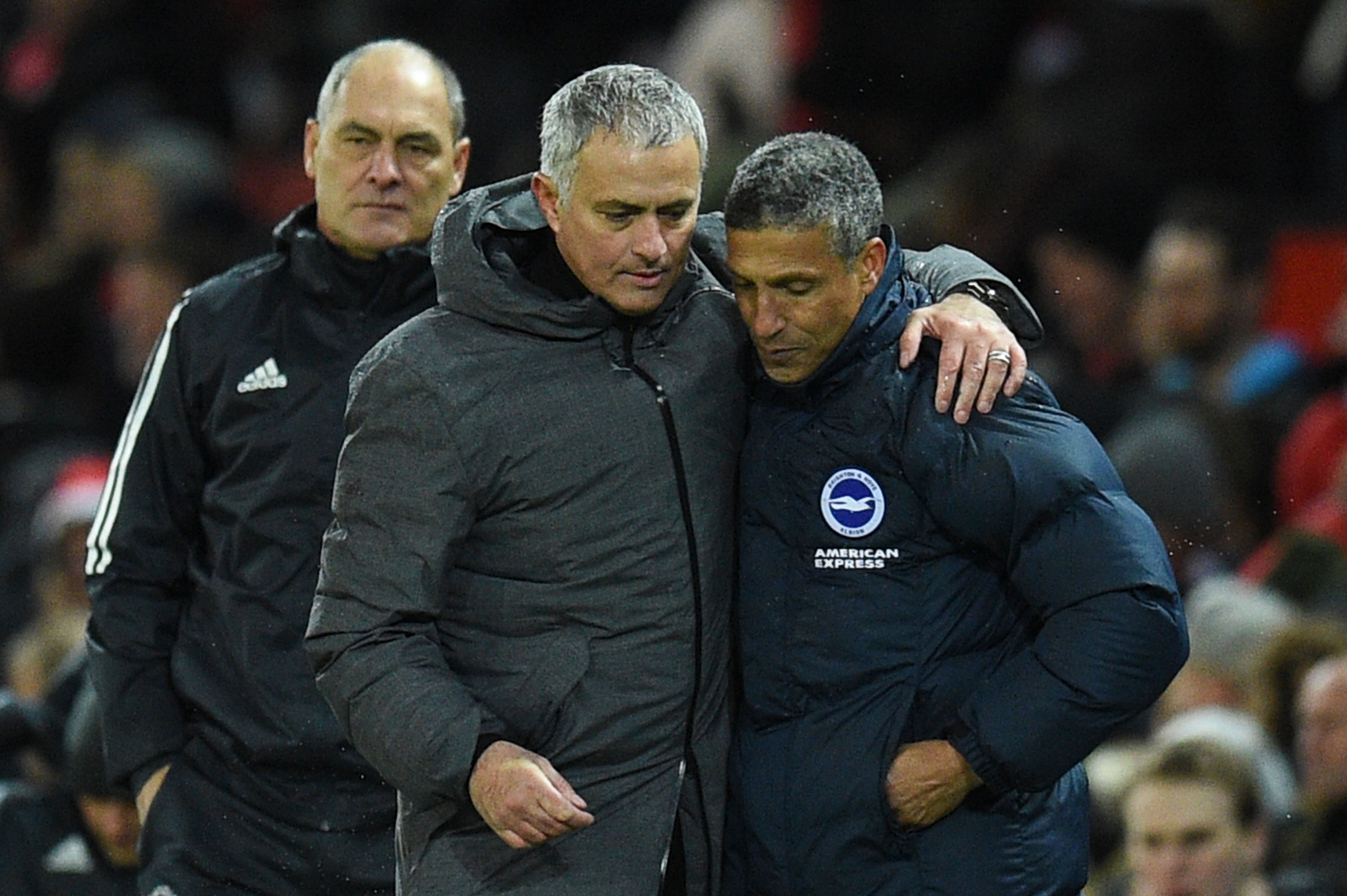 Manchester United's Portuguese manager Jose Mourinho (2R) leaves the pitch with Brighton's Irish manager Chris Hughton (R) during the English Premier League football match between Manchester United and Brighton and Hove Albion at Old Trafford in Manchester, north west England, on November 25, 2017. / AFP PHOTO / Oli SCARFF / RESTRICTED TO EDITORIAL USE. No use with unauthorized audio, video, data, fixture lists, club/league logos or 'live' services. Online in-match use limited to 75 images, no video emulation. No use in betting, games or single club/league/player publications.  /         (Photo credit should read OLI SCARFF/AFP/Getty Images)