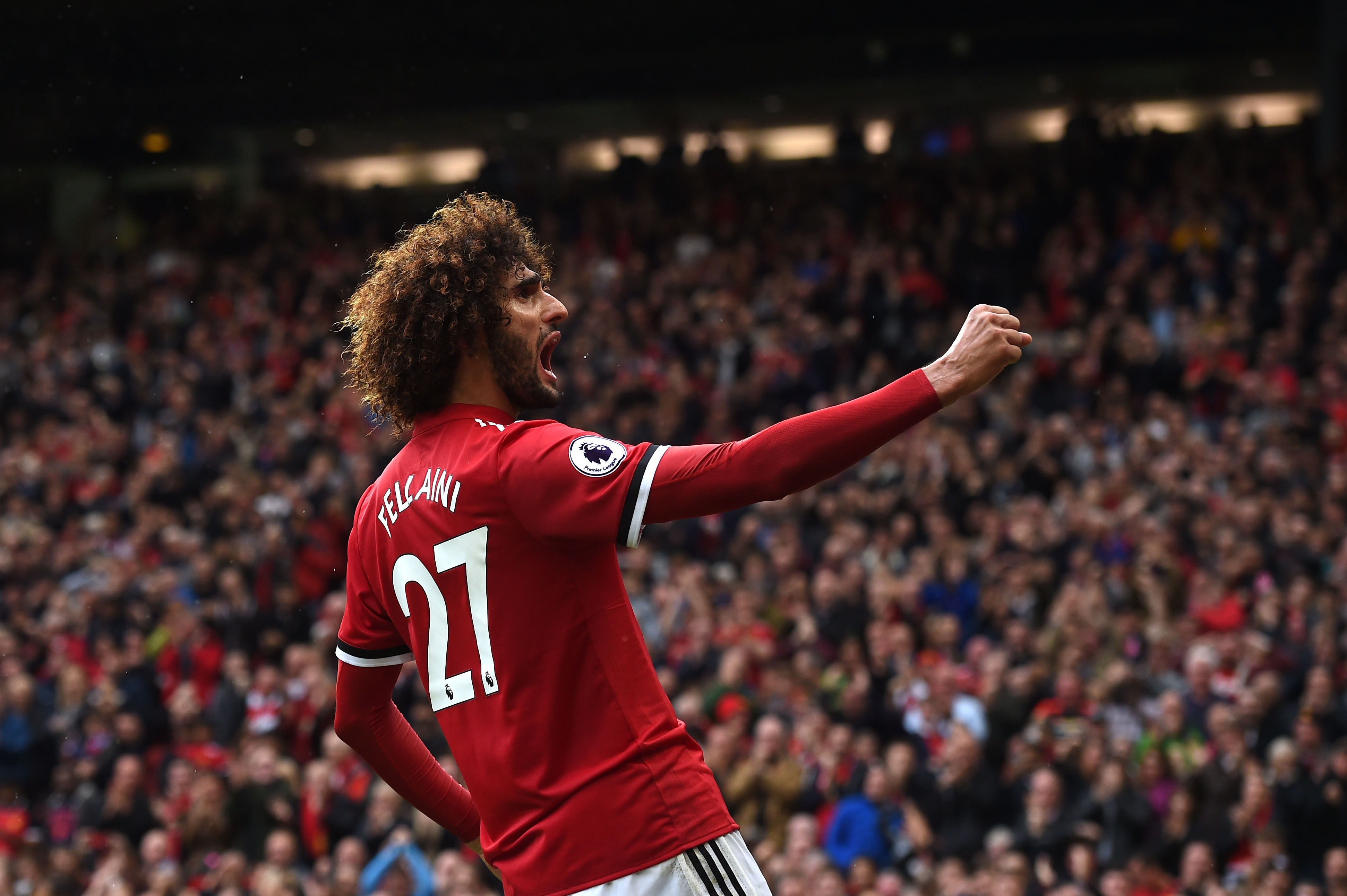 Manchester United's Belgian midfielder Marouane Fellaini celebrates scoring  the team's second goal during the English Premier League football match between Manchester United and Crystal Palace at Old Trafford in Manchester, north west England, on September 30, 2017. / AFP PHOTO / PAUL ELLIS / RESTRICTED TO EDITORIAL USE. No use with unauthorized audio, video, data, fixture lists, club/league logos or 'live' services. Online in-match use limited to 75 images, no video emulation. No use in betting, games or single club/league/player publications.  /         (Photo credit should read PAUL ELLIS/AFP/Getty Images)