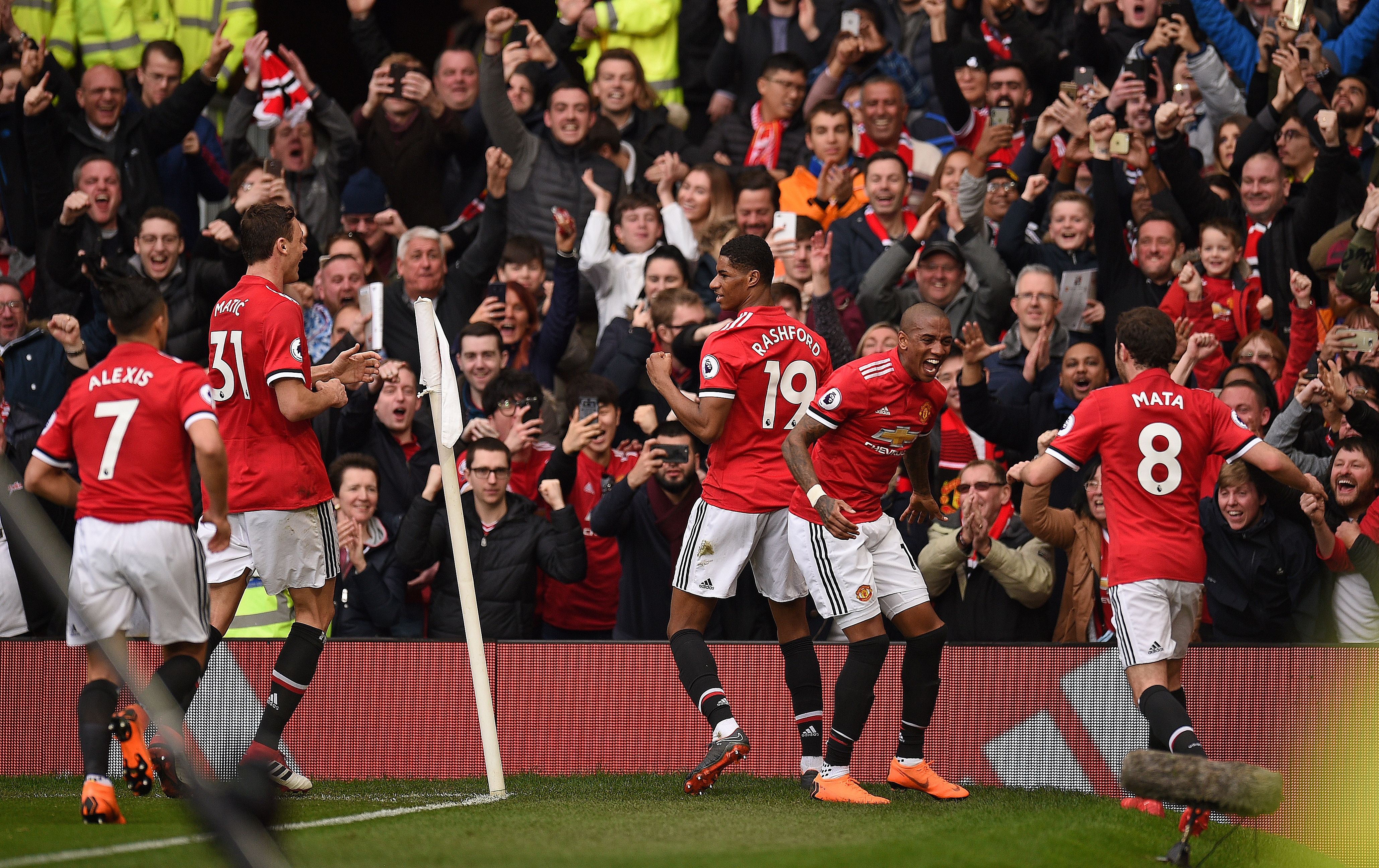 Manchester United players celebrate after Manchester United's English striker Marcus Rashford (C) scored their second goal during the English Premier League football match between Manchester United and Liverpool at Old Trafford in Manchester, north west England, on March 10, 2018. / AFP PHOTO / Oli SCARFF / RESTRICTED TO EDITORIAL USE. No use with unauthorized audio, video, data, fixture lists, club/league logos or 'live' services. Online in-match use limited to 75 images, no video emulation. No use in betting, games or single club/league/player publications.  /         (Photo credit should read OLI SCARFF/AFP/Getty Images)
