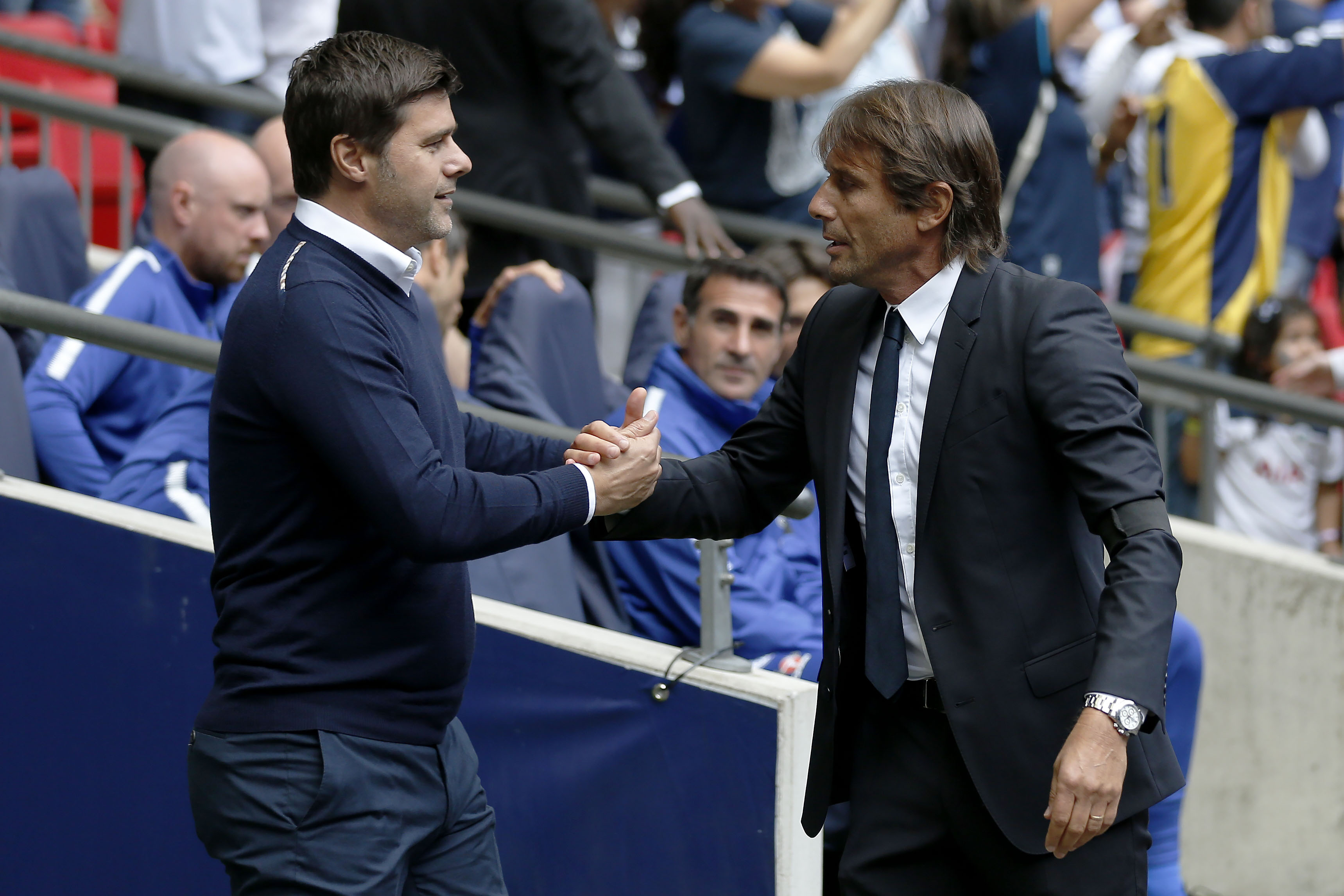 Tottenham Hotspur's Argentinian head coach Mauricio Pochettino (L) and Chelsea's Italian head coach Antonio Conte greet before the English Premier League football match between Tottenham Hotspur and Chelsea at Wembley Stadium in London, on August 20, 2017. / AFP PHOTO / IKIMAGES / Ian KINGTON / RESTRICTED TO EDITORIAL USE. No use with unauthorized audio, video, data, fixture lists, club/league logos or 'live' services. Online in-match use limited to 45 images, no video emulation. No use in betting, games or single club/league/player publications.        (Photo credit should read IAN KINGTON/AFP/Getty Images)