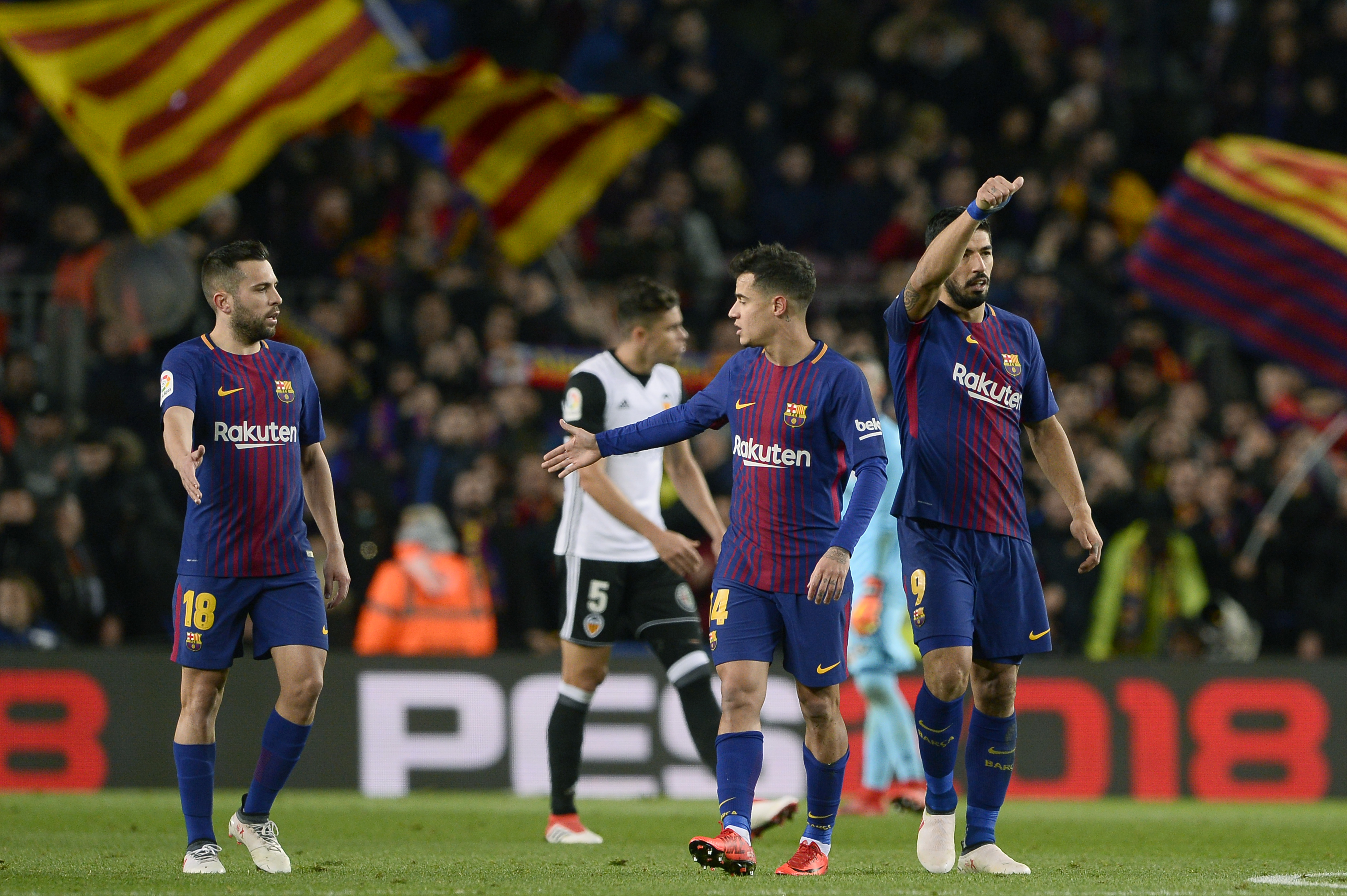 Barcelona's Uruguayan forward Luis Suarez (R) celebrates with Barcelona's Brazilian midfielder Philippe Coutinho (C) and Barcelona's Spanish defender Jordi Alba after scoring during the Spanish 'Copa del Rey' (King's cup) first leg semi-final football match between FC Barcelona and Valencia CF at the Camp Nou stadium in Barcelona on February 01, 2018. / AFP PHOTO / Josep LAGO        (Photo credit should read JOSEP LAGO/AFP/Getty Images)