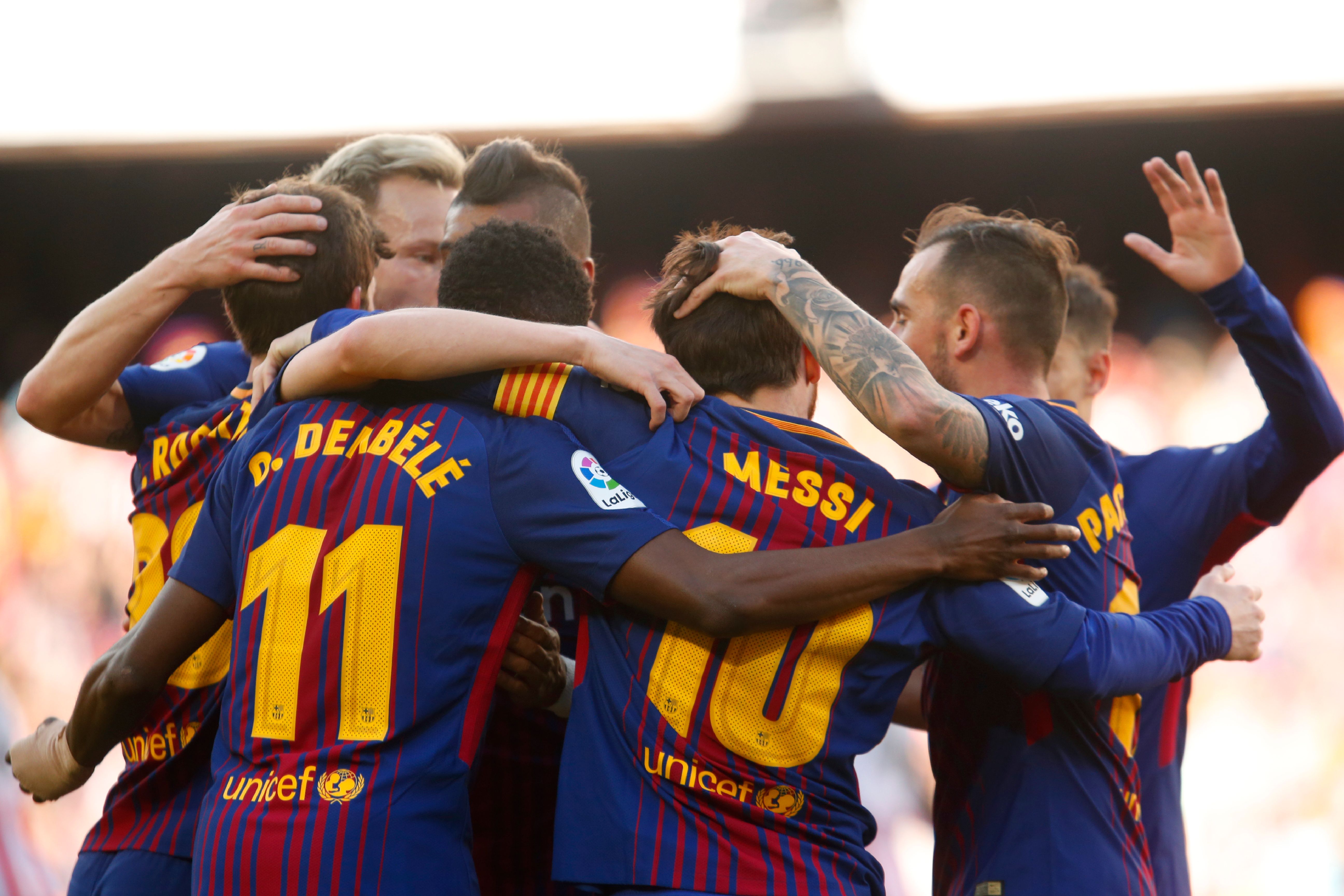 Barcelona's Argentinian forward Lionel Messi (C) celebrates with teammates after scoring during the Spanish League football match between FC Barcelona and Athletic Club Bilbao at the Camp Nou stadium in Barcelona on March 18, 2018. / AFP PHOTO / Pau Barrena        (Photo credit should read PAU BARRENA/AFP/Getty Images)