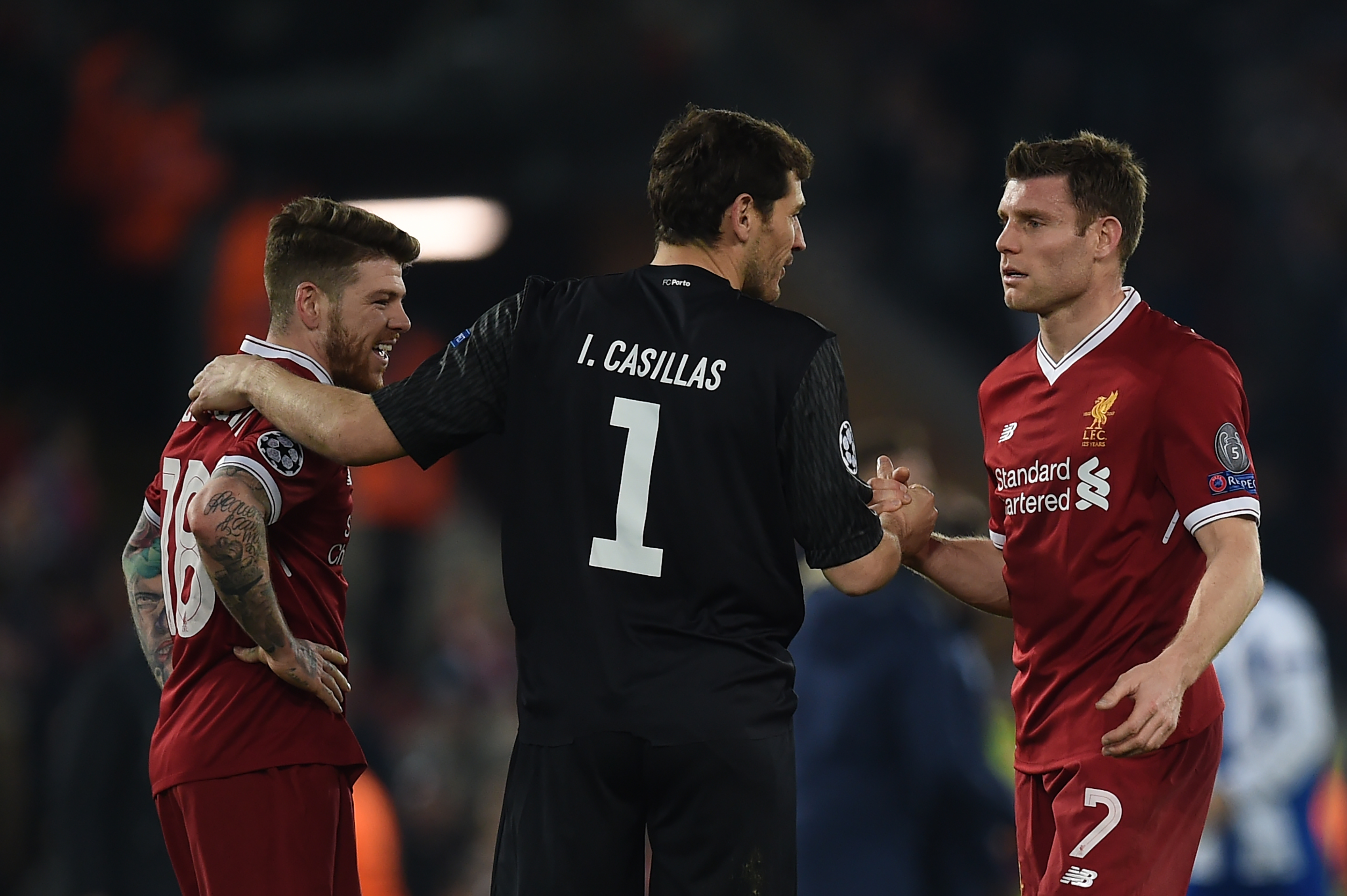Porto's Spanish goalkeeper Iker Casillas (C) greets Liverpool's Spanish defender Alberto Moreno (L) and Liverpool's English midfielder James Milner after the UEFA Champions League round of sixteen second leg football match between Liverpool and FC Porto at Anfield in Liverpool, north-west England on March 6, 2018. / AFP PHOTO / PAUL ELLIS        (Photo credit should read PAUL ELLIS/AFP/Getty Images)