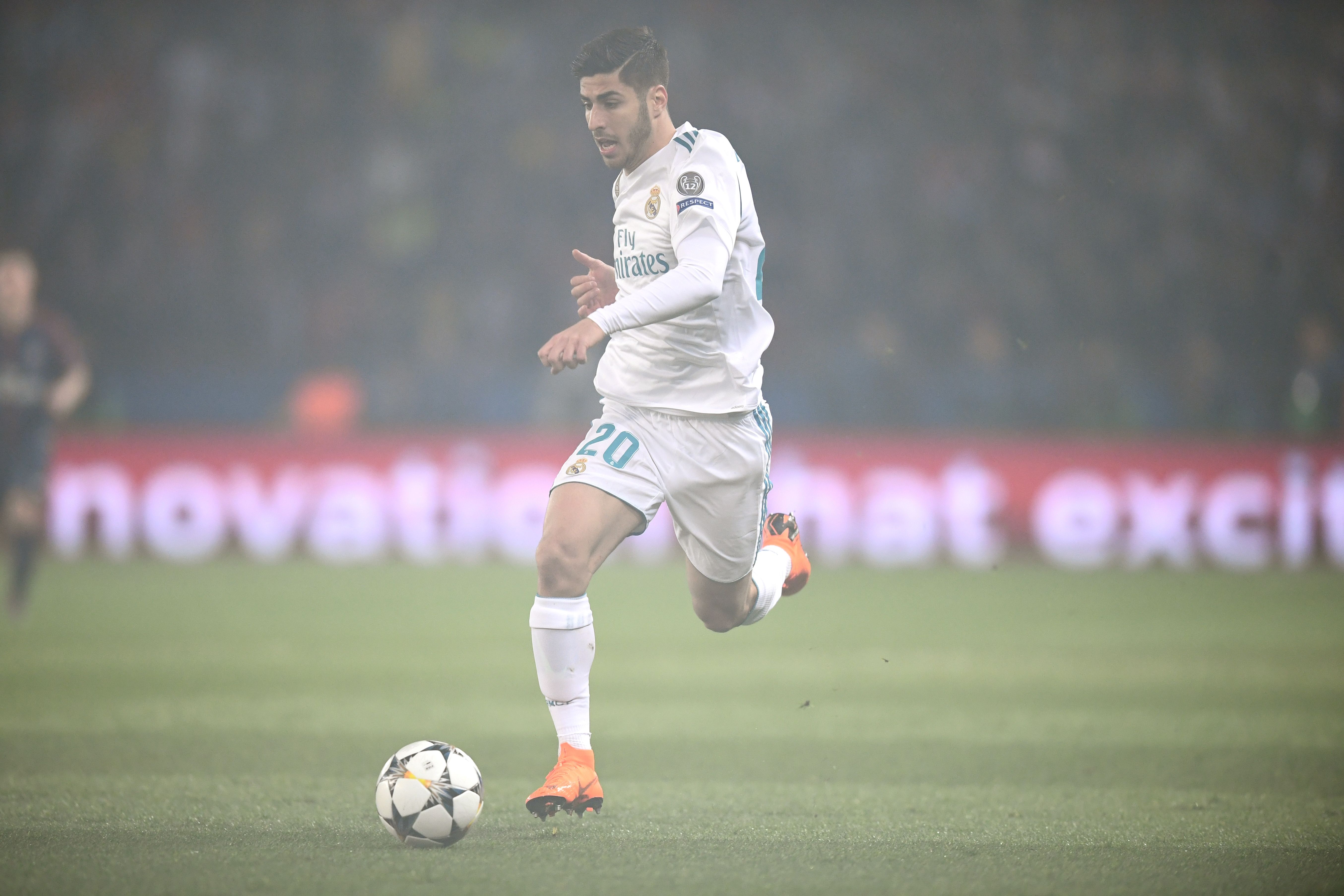 Real Madrid's Spanish midfielder Marco Asensio runs with the ball during the UEFA Champions League round of 16 second leg football match between Paris Saint-Germain (PSG) and Real Madrid on March 6, 2018, at the Parc des Princes stadium in Paris. / AFP PHOTO / FRANCK FIFE        (Photo credit should read FRANCK FIFE/AFP/Getty Images)