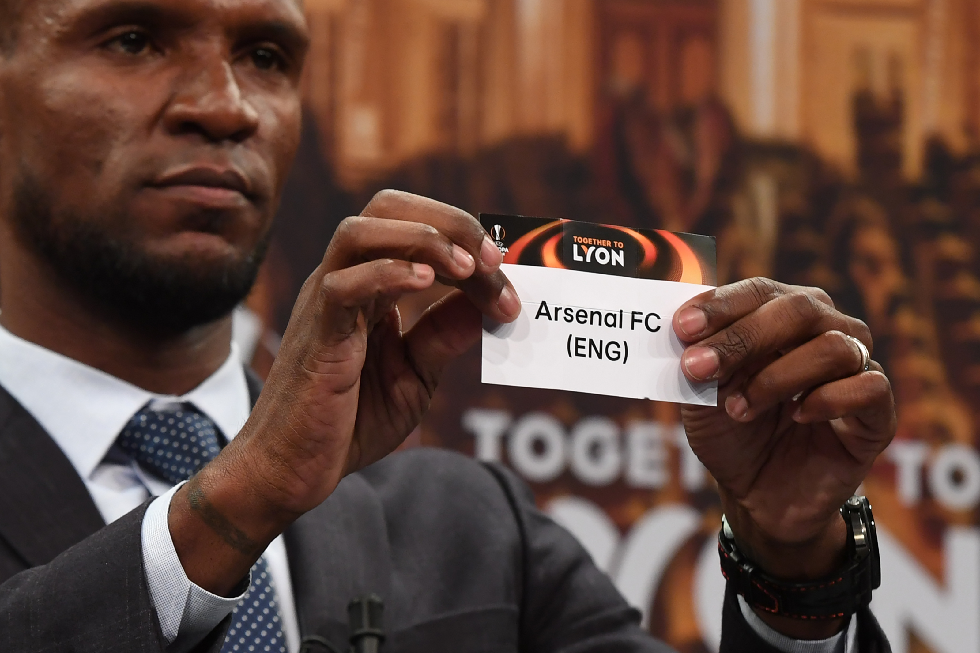 Barcelona and Lyon's former player Eric Abidal shows the name of Arsenal FC during the draw for the round of 16 of the UEFA Europa League football tournament at the UEFA headquarters in Nyon, Switzerland on February 23, 2018.

 / AFP PHOTO / jean-guy PYTHON        (Photo credit should read JEAN-GUY PYTHON/AFP/Getty Images)