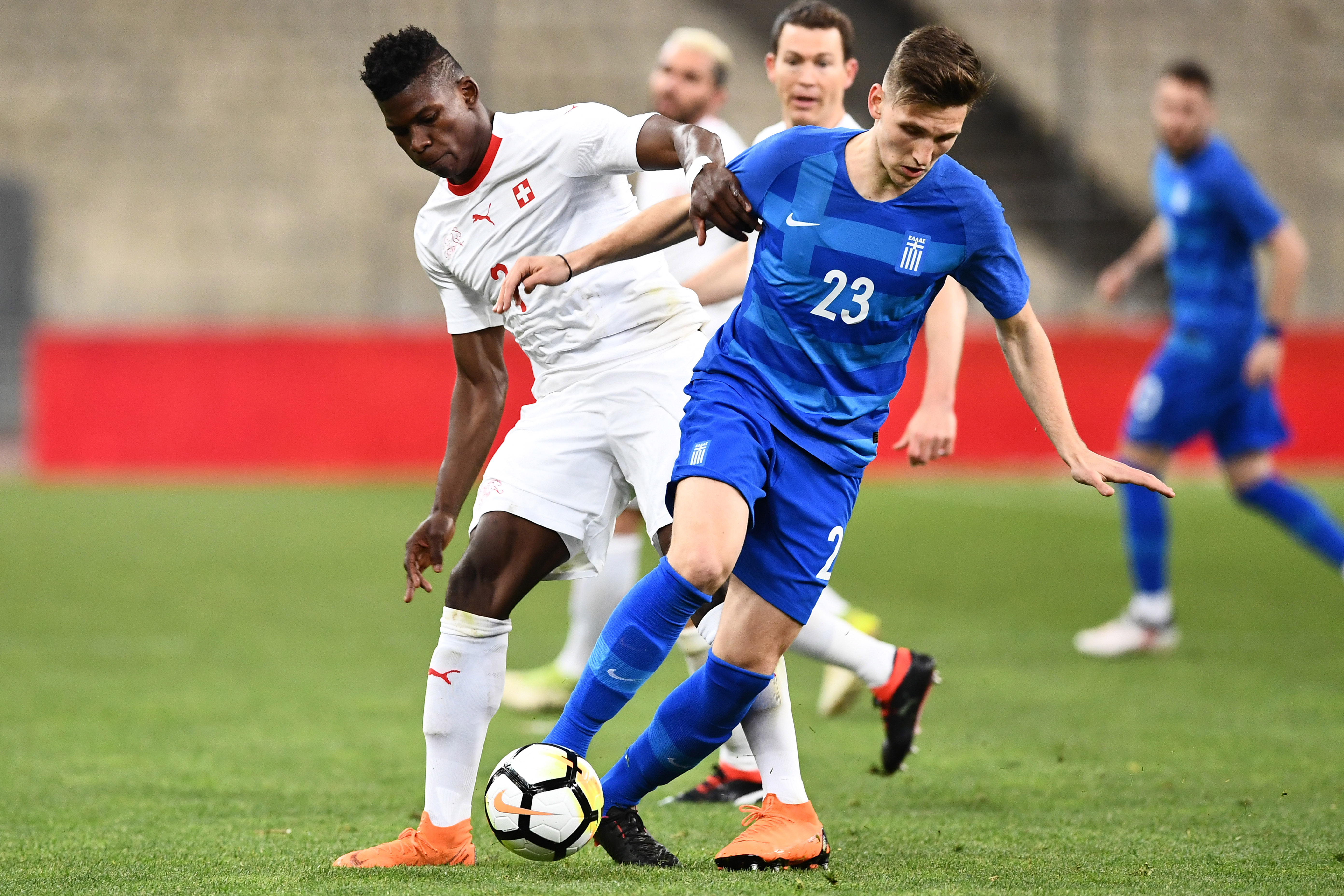 Greece's Panagiotis Retsos (R) fights for the ball with Switzerland's Breel Embolo during the international friendly football match between Greece and Switzerland in Athens on March 23, 2018. / AFP PHOTO / ARIS MESSINIS        (Photo credit should read ARIS MESSINIS/AFP/Getty Images)