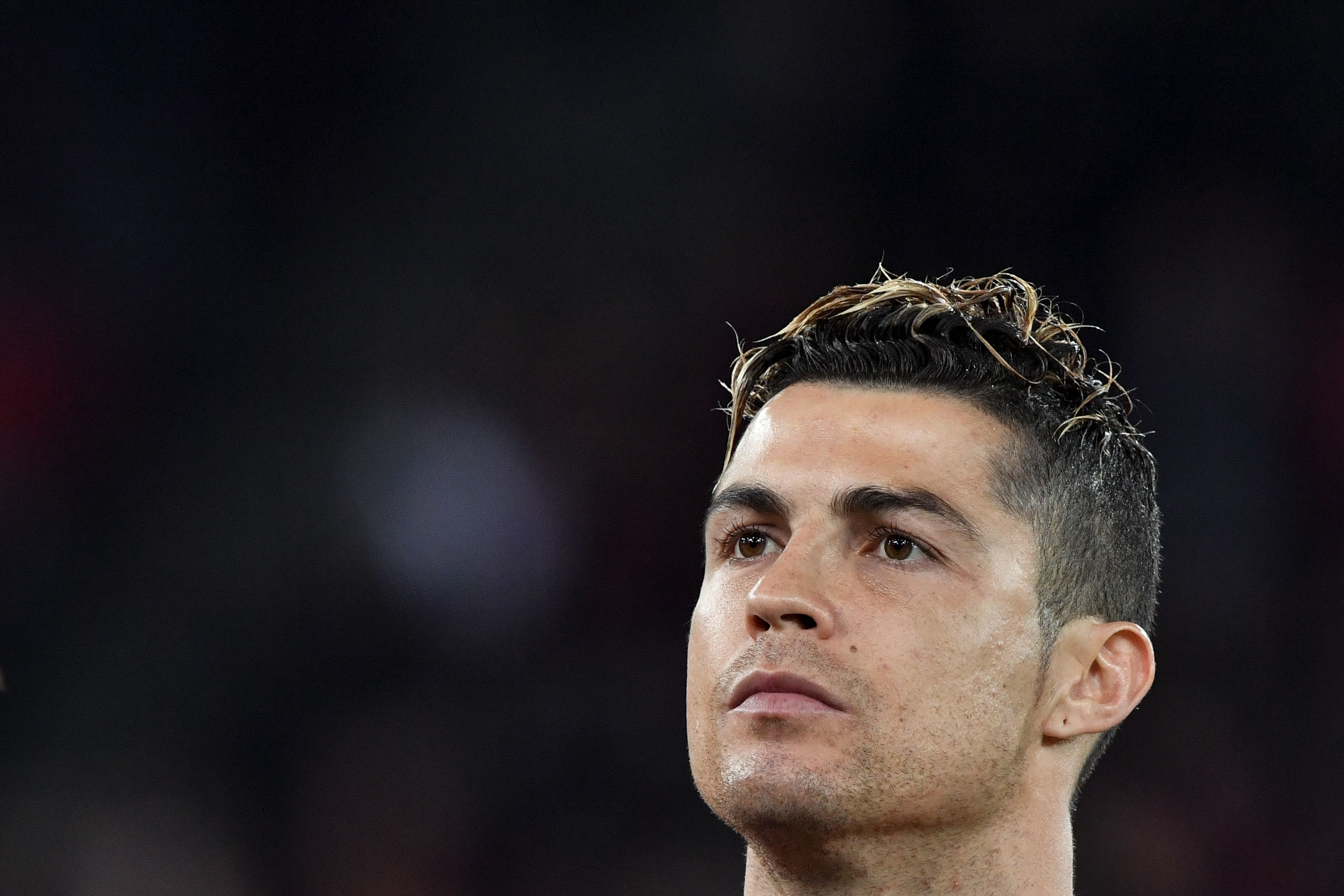 Portugal's forward Cristiano Ronaldo stands during the national anthems prior to an international friendly football match between Portugal and Egypt at Letzigrund stadium in Zurich on March 23, 2018. / AFP PHOTO / Fabrice COFFRINI        (Photo credit should read FABRICE COFFRINI/AFP/Getty Images)