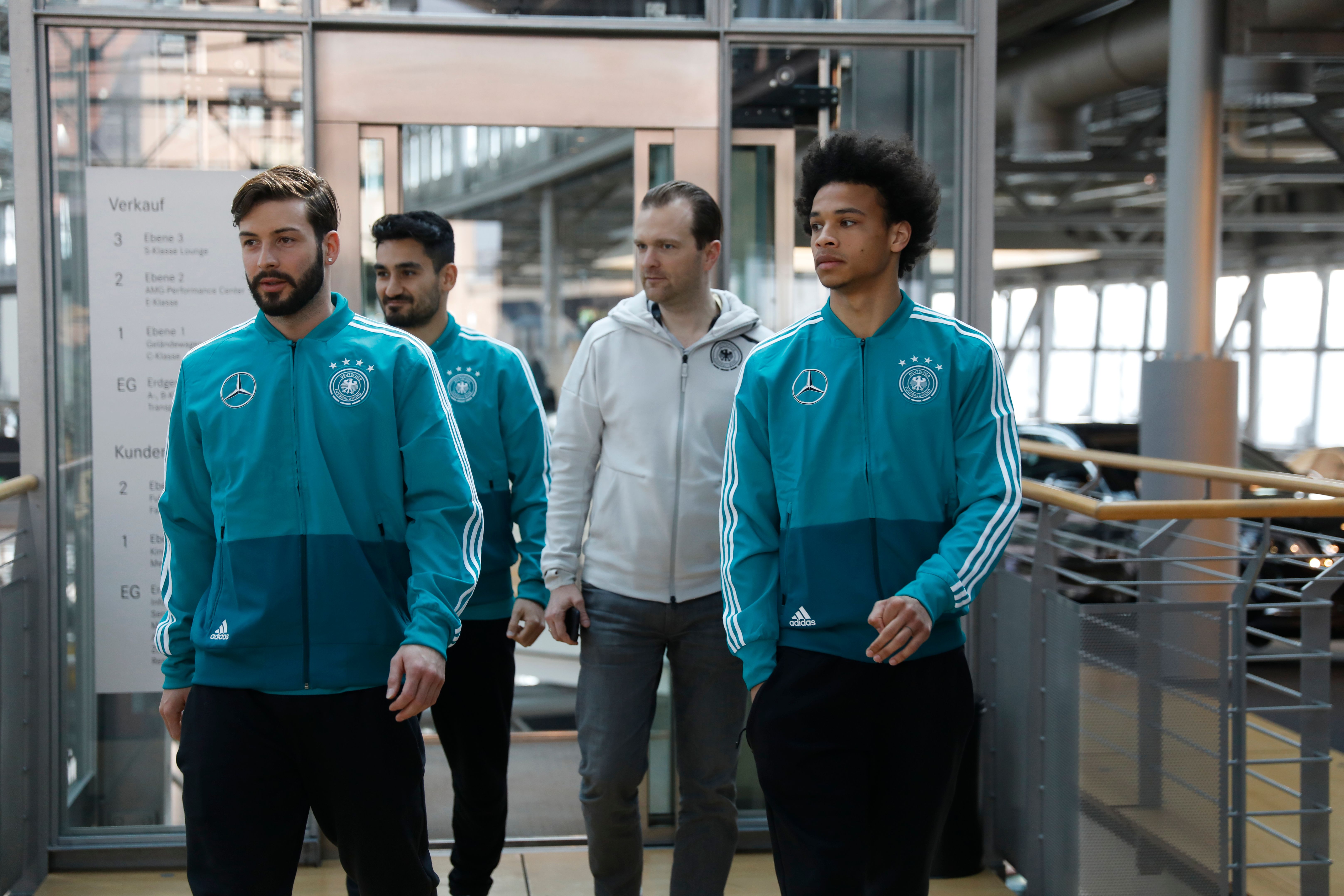 (LtoR) German defender Marvin Plattenhardt, German midfielder Leroy Sane and German midfielder Ilkay Gundogan (R) arrive to address a press conference of the German national football team in Berlin on March 25, 2018, ahead of their friendly football match against Brazil on March 27. / AFP PHOTO / Odd ANDERSEN        (Photo credit should read ODD ANDERSEN/AFP/Getty Images)