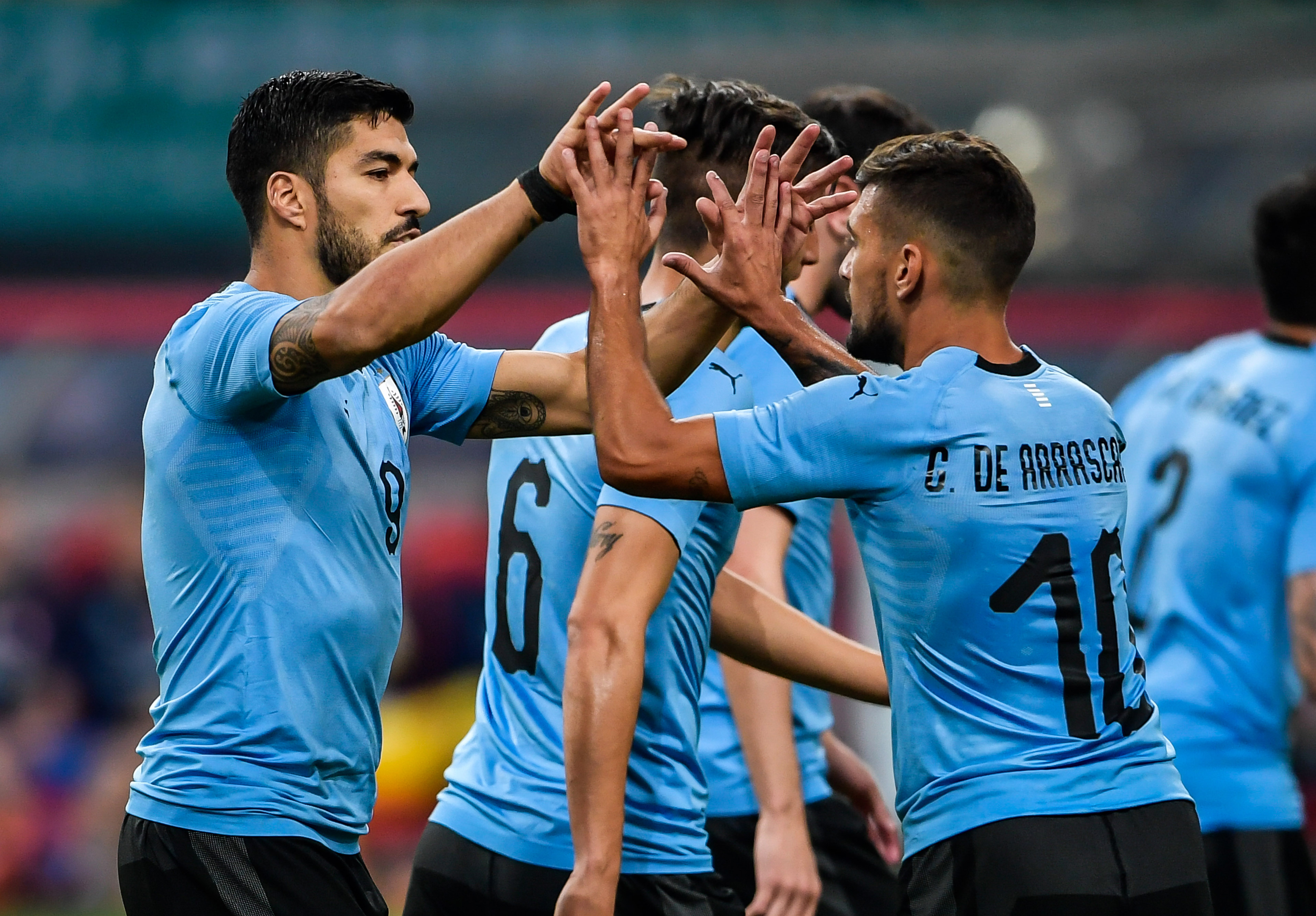 Luis Suarez (L) of Uruguay celebrates with teammate Giorian De Arrascaeta (R, #10) during their China Cup International Football Championship Semi-final match against Czech in Nanning in China's southern Guangxi region on March 23, 2018. / AFP PHOTO / - / China OUT        (Photo credit should read -/AFP/Getty Images)