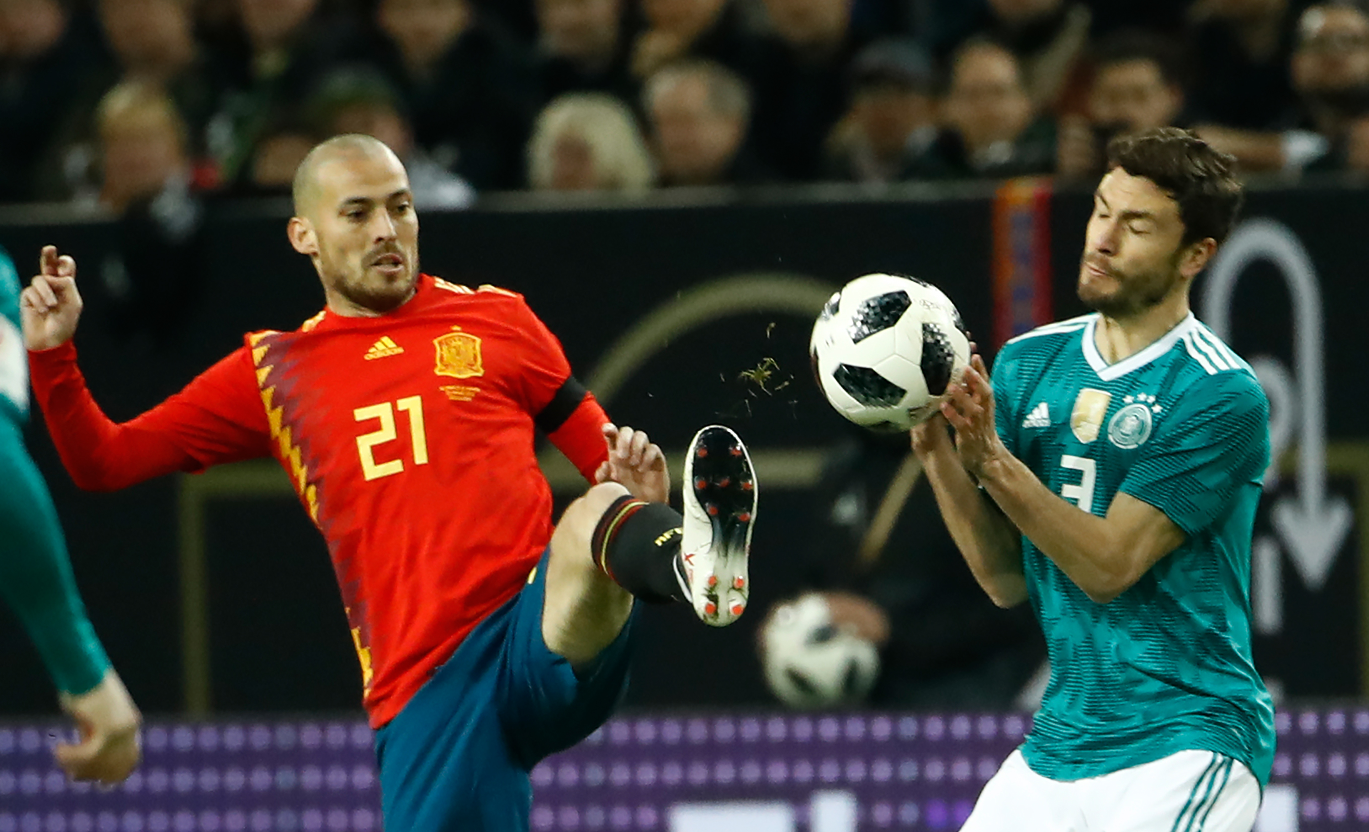 Germany's defender Jonas Hector (R) and Spain's midfielder David Silva (C) vie for the ball during the international friendly football match of Germany vs Spain in Duesseldorf, western Germany, on March 23, 2018, in preparation of the 2018 Fifa World Cup. / AFP PHOTO / Odd ANDERSEN        (Photo credit should read ODD ANDERSEN/AFP/Getty Images)