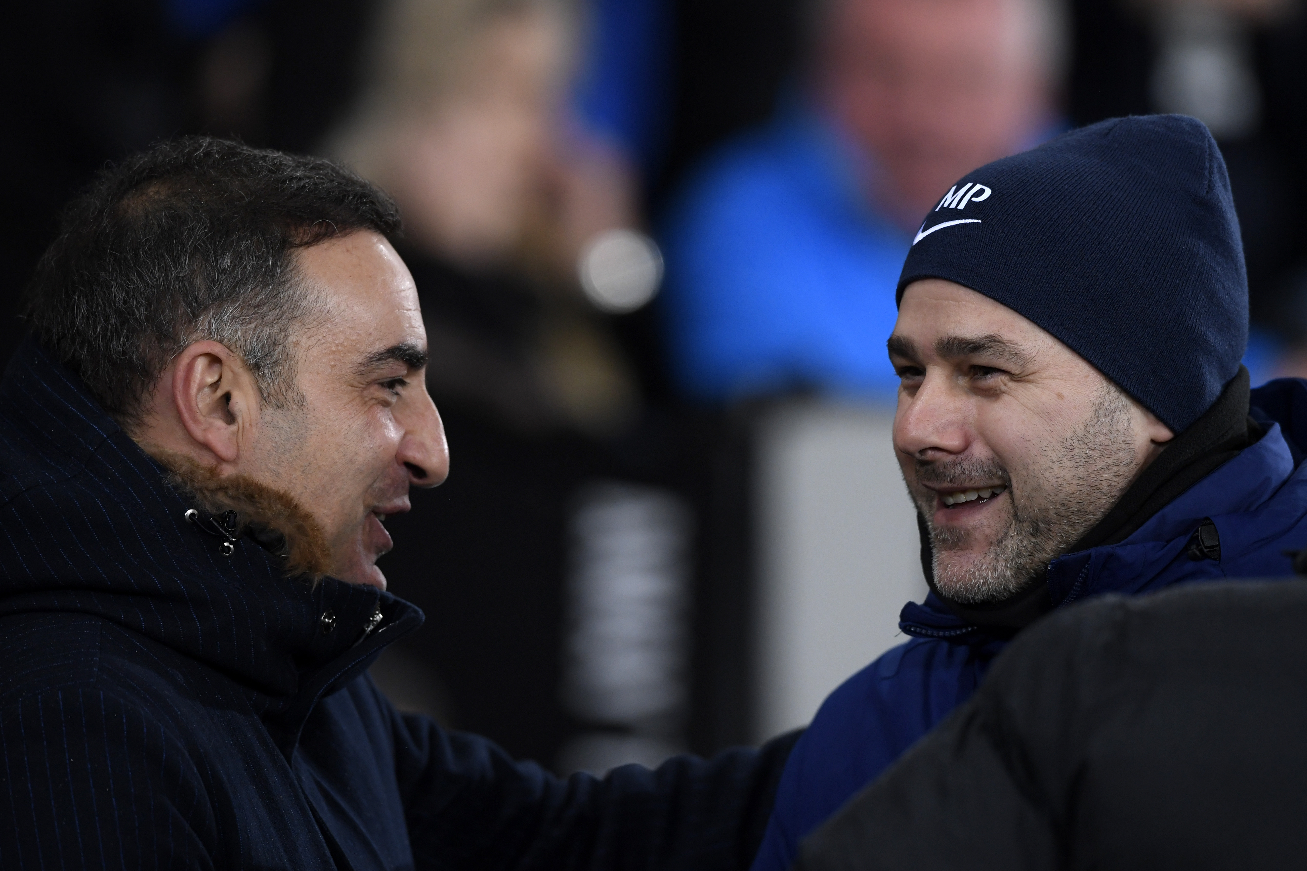 SWANSEA, WALES - JANUARY 02: Carlos Carvalhal, Manager of Swansea City and Mauricio Pochettino, Manager of Tottenham Hotspur embrace prior to the Premier League match between Swansea City and Tottenham Hotspur at Liberty Stadium on January 2, 2018 in Swansea, Wales.  (Photo by Stu Forster/Getty Images)