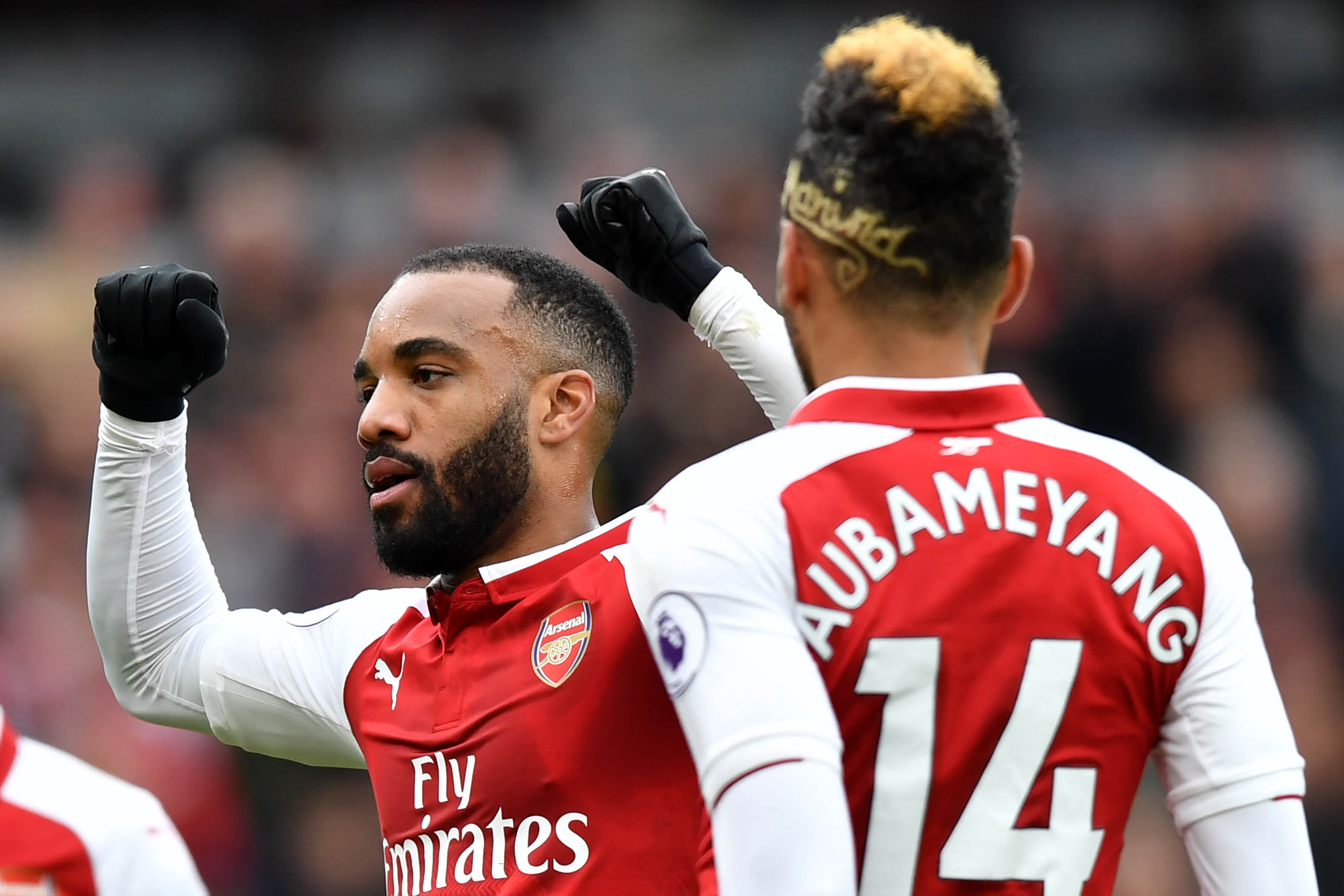 Arsenal's French striker Alexandre Lacazette (L) celerates scoring the team's third goal during the English Premier League football match between Arsenal and Stoke City at the Emirates Stadium in London on April 1, 2018.  / AFP PHOTO / Oliver GREENWOOD / RESTRICTED TO EDITORIAL USE. No use with unauthorized audio, video, data, fixture lists, club/league logos or 'live' services. Online in-match use limited to 75 images, no video emulation. No use in betting, games or single club/league/player publications.  /         (Photo credit should read OLIVER GREENWOOD/AFP/Getty Images)