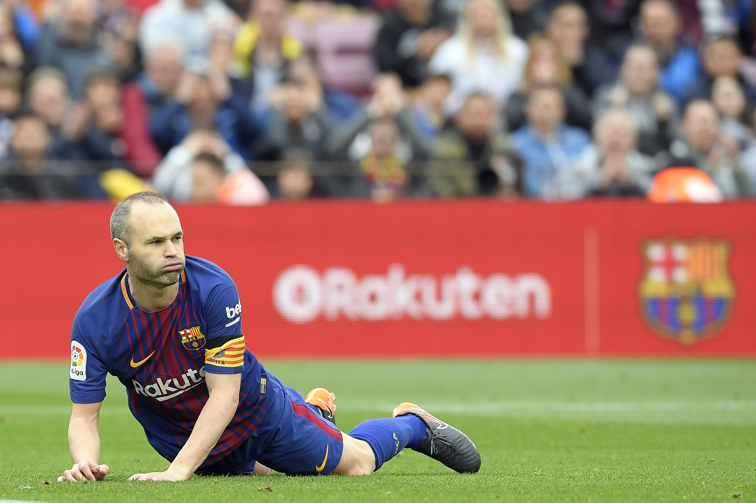 Barcelona's Spanish midfielder Andres Iniesta lies on the field during the Spanish league footbal match between FC Barcelona and Valencia CF at the Camp Nou stadium in Barcelona on April 14, 2018. / AFP PHOTO / LLUIS GENE        (Photo credit should read LLUIS GENE/AFP/Getty Images)