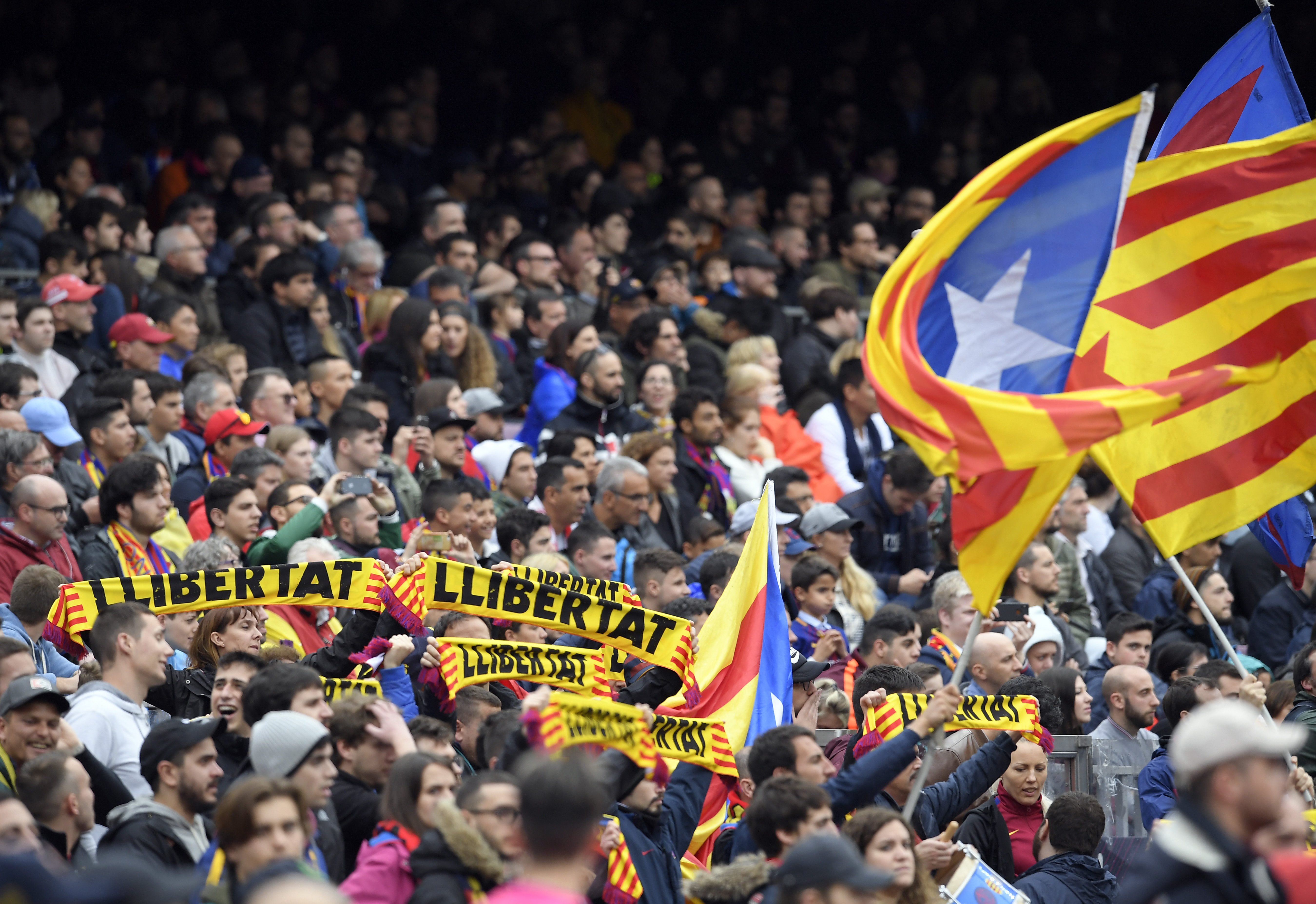 Barcelona fans hold up scarves demanding freedom during the Spanish league footbal match between FC Barcelona and Valencia CF at the Camp Nou stadium in Barcelona on April 14, 2018. / AFP PHOTO / LLUIS GENE        (Photo credit should read LLUIS GENE/AFP/Getty Images)