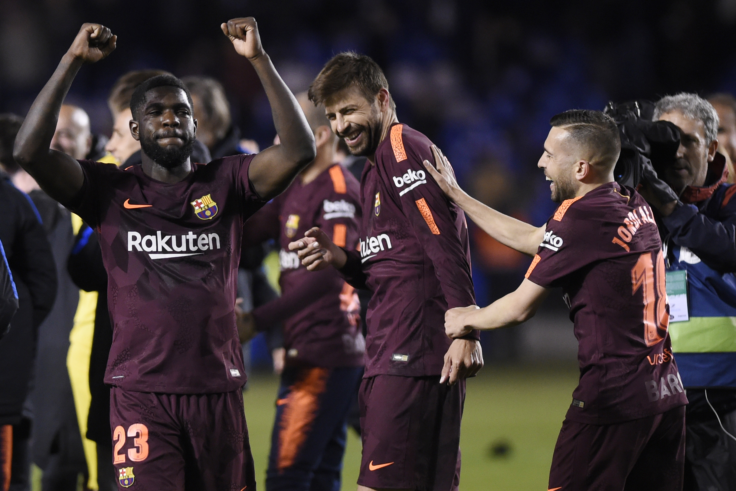 (L-R) Barcelona's French defender Samuel Umtiti, Barcelona's Spanish defender Gerard Pique and Barcelona's Spanish defender Jordi Alba celebrate after their team won the Spanish league football match against Deportivo Coruna and claimed their 25th La Liga at the Riazor stadium in Coruna on April 29, 2018. (Photo by MIGUEL RIOPA / AFP)        (Photo credit should read MIGUEL RIOPA/AFP/Getty Images)