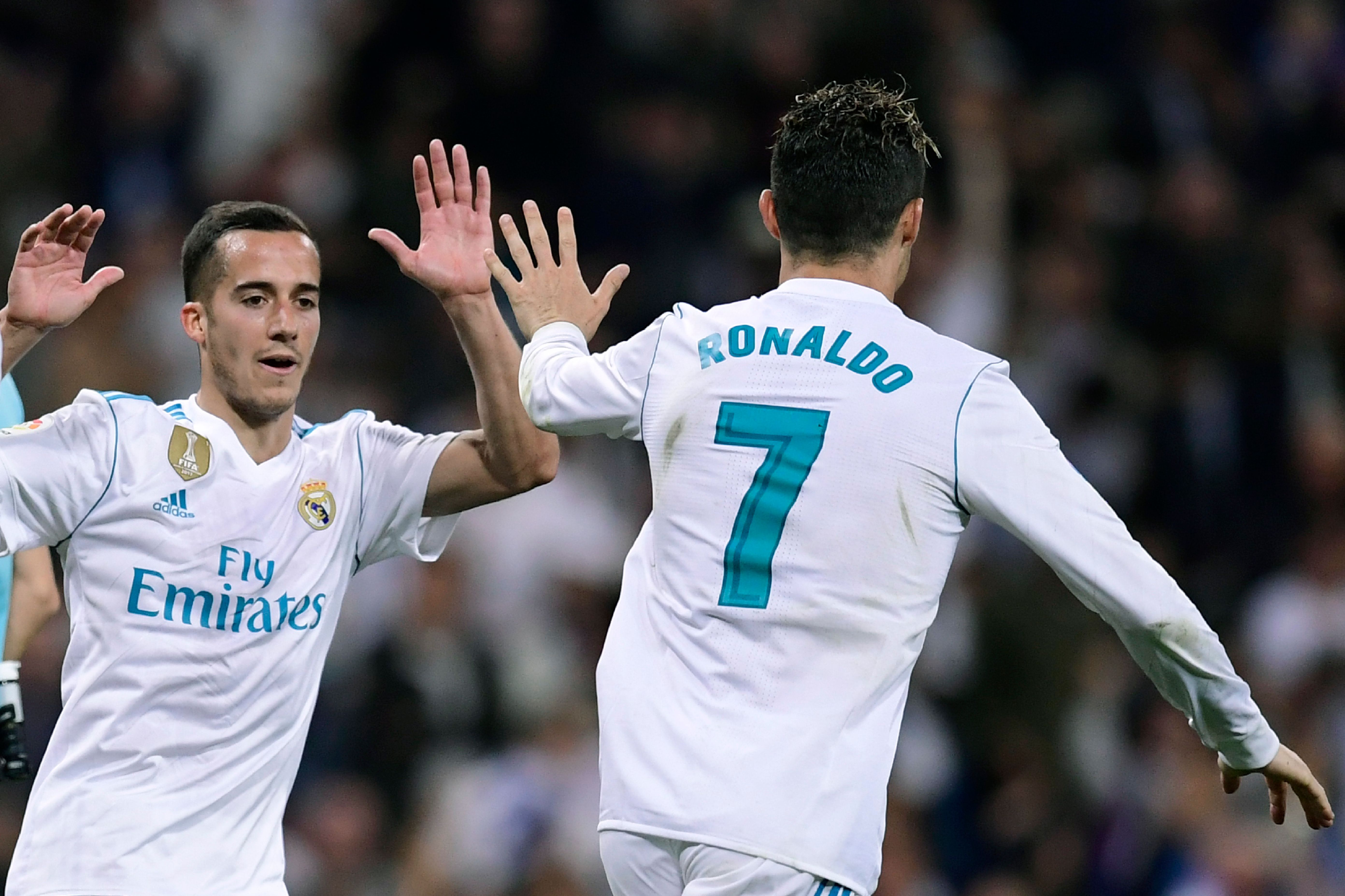 Real Madrid's Portuguese forward Cristiano Ronaldo (R) celebrates with Real Madrid's Spanish midfielder Lucas Vazquez after scoring during the Spanish league football match Real Madrid CF against Athletic Club Bilbao at the Santiago Bernabeu stadium in adrid on April 18, 2018. / AFP PHOTO / JAVIER SORIANO        (Photo credit should read JAVIER SORIANO/AFP/Getty Images)