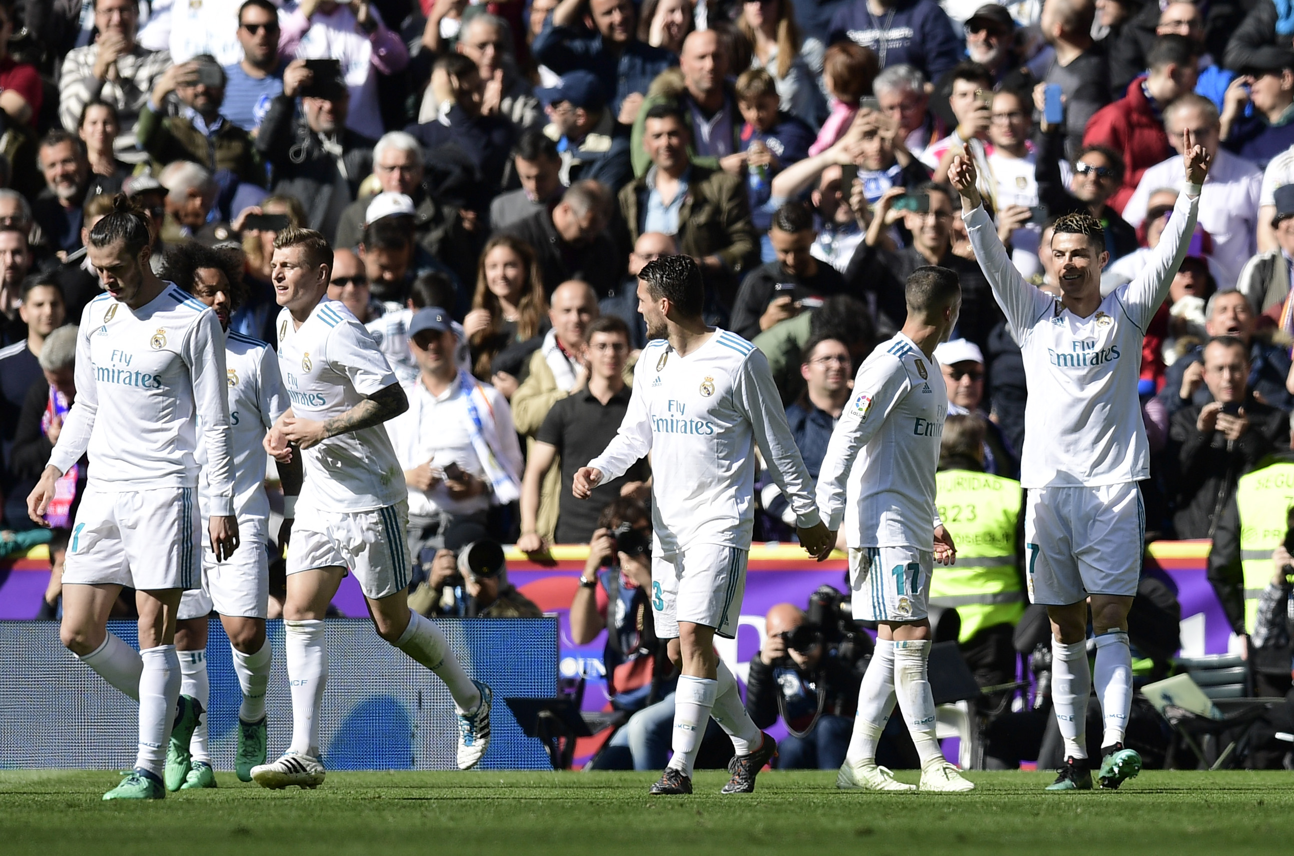 Real Madrid's Portuguese forward Cristiano Ronaldo (R) celebrates a goal during the Spanish league football match between Real Madrid CF and Club Atletico de Madrid at the Santiago Bernabeu stadium in Madrid on April 8, 2018. / AFP PHOTO / JAVIER SORIANO        (Photo credit should read JAVIER SORIANO/AFP/Getty Images)