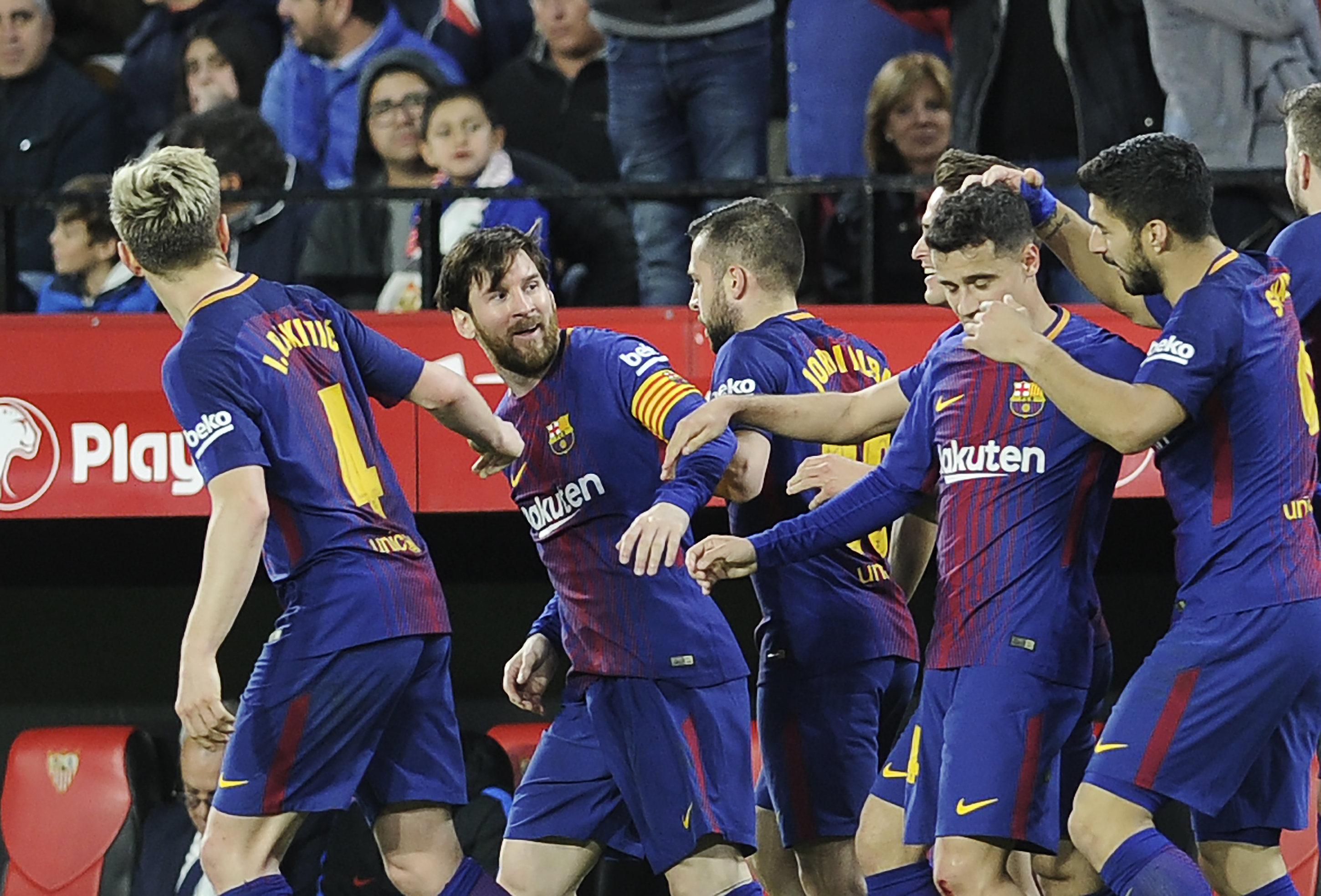 Barcelona's Argentinian forward Lionel Messi (2L) celebrates a goal with teammates during the Spanish League football match between Sevilla FC and FC Barcelona at the Ramon Sanchez Pizjuan stadium on March 31, 2018. / AFP PHOTO / Cristina Quicler        (Photo credit should read CRISTINA QUICLER/AFP/Getty Images)