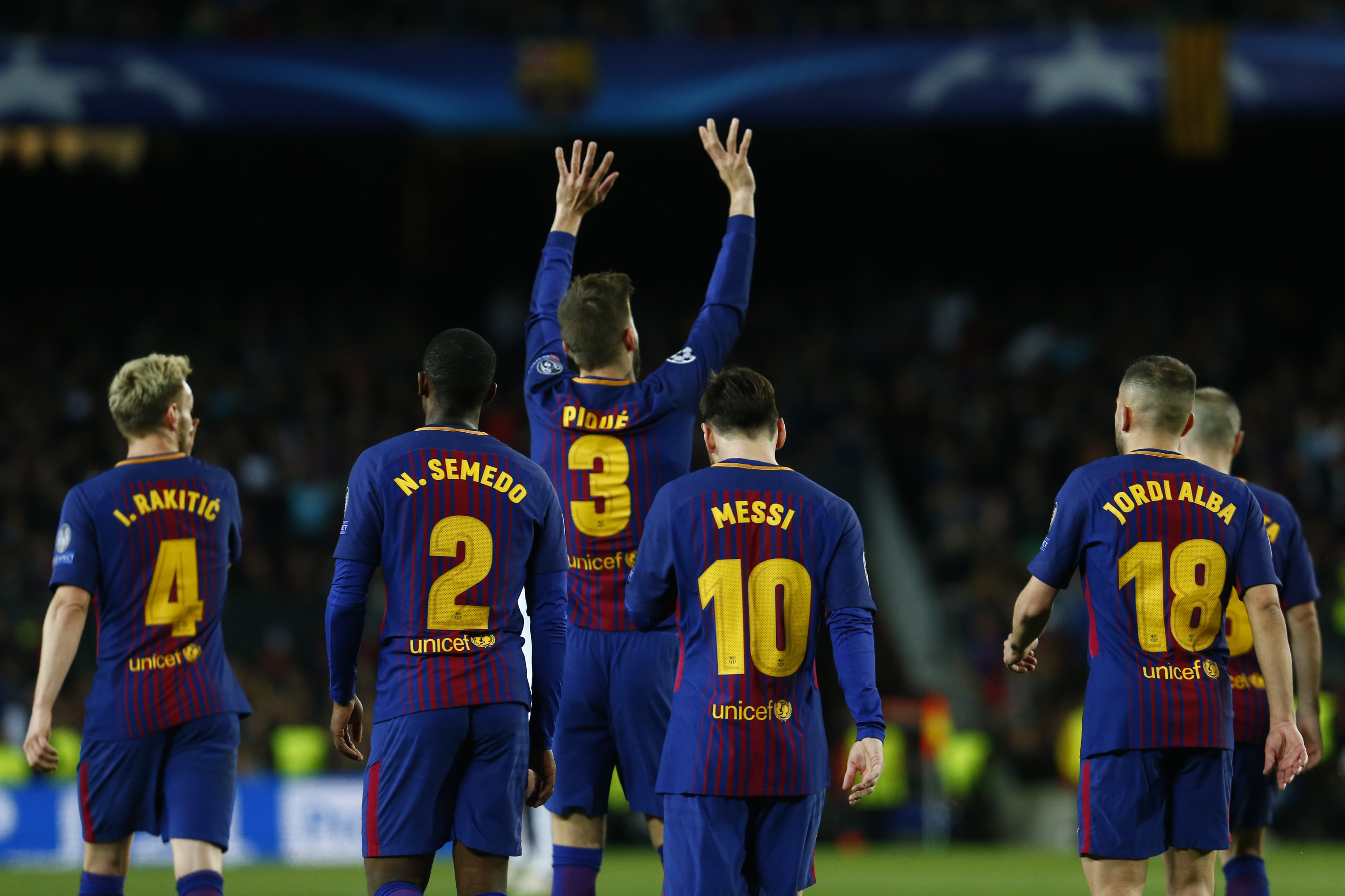 Barcelona's Spanish defender Gerard Pique (C) celebrates a goal during the UEFA Champions League quarter-final first leg football match between FC Barcelona and AS Roma at the Camp Nou Stadium in Barcelona on April 4, 2018. / AFP PHOTO / Pau Barrena        (Photo credit should read PAU BARRENA/AFP/Getty Images)