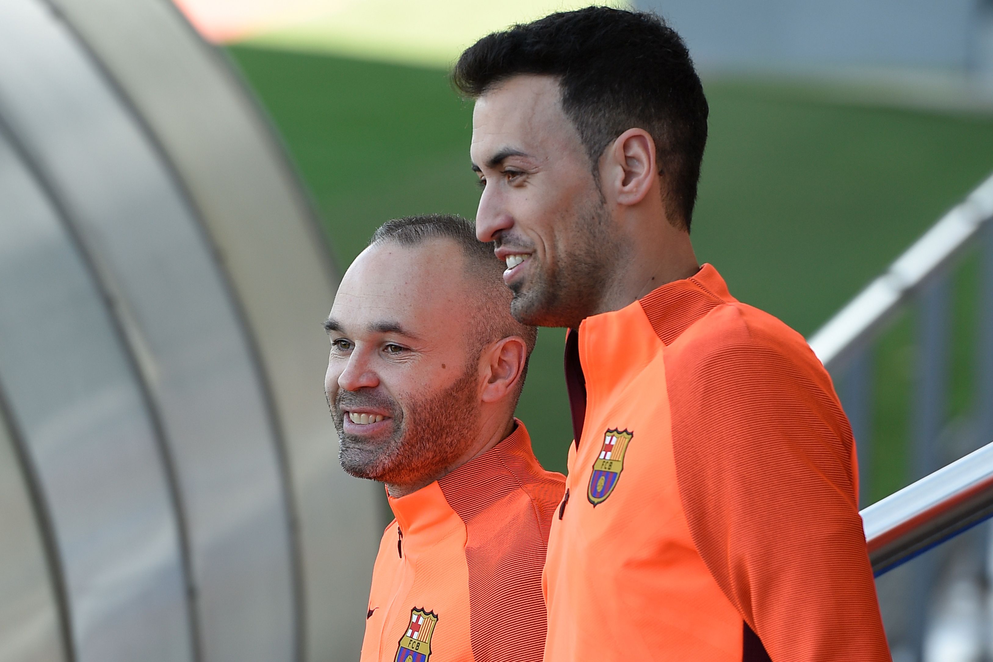 Barcelona's midfielder Sergio Busquets (R) and Barcelona's midfielder Andres Iniesta (L) arrive at the Joan Gamper Sports Center in Sant Joan Despi near Barcelona on April 3, 2018 on the eve their UEFA Champions League quarter-final first leg football match between Barcelona and AS Roma. / AFP PHOTO / LLUIS GENE        (Photo credit should read LLUIS GENE/AFP/Getty Images)