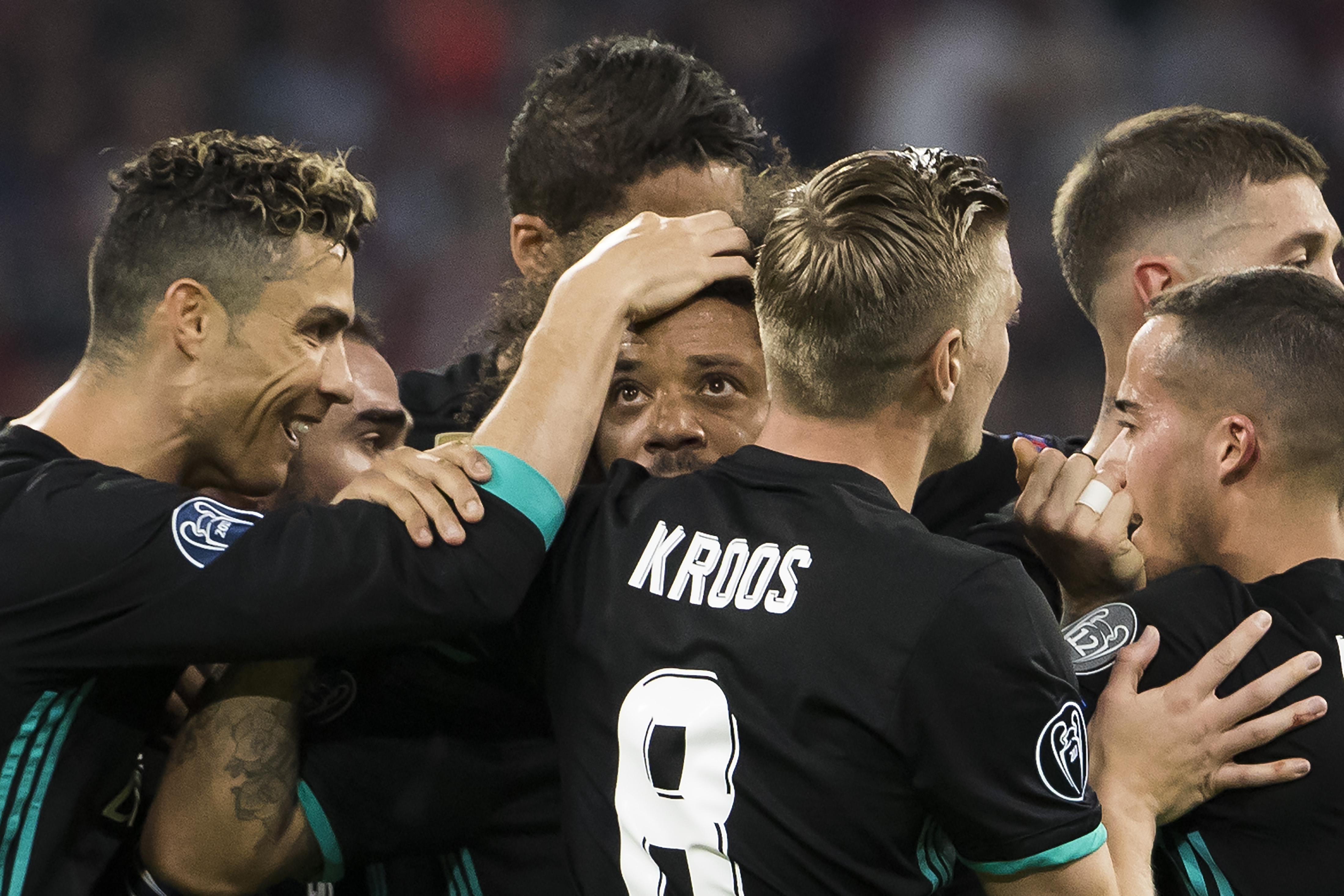 Real Madrid's Brazilian defender Marcelo (C) is congratulated after scoring by Real Madrid's Portuguese forward Cristiano Ronaldo (L) and other team matesd during the UEFA Champions League semi-final first-leg football match FC Bayern Munich v Real Madrid CF in Munich, southern Germany on April 25, 2018. (Photo by ODD ANDERSEN / AFP)        (Photo credit should read ODD ANDERSEN/AFP/Getty Images)