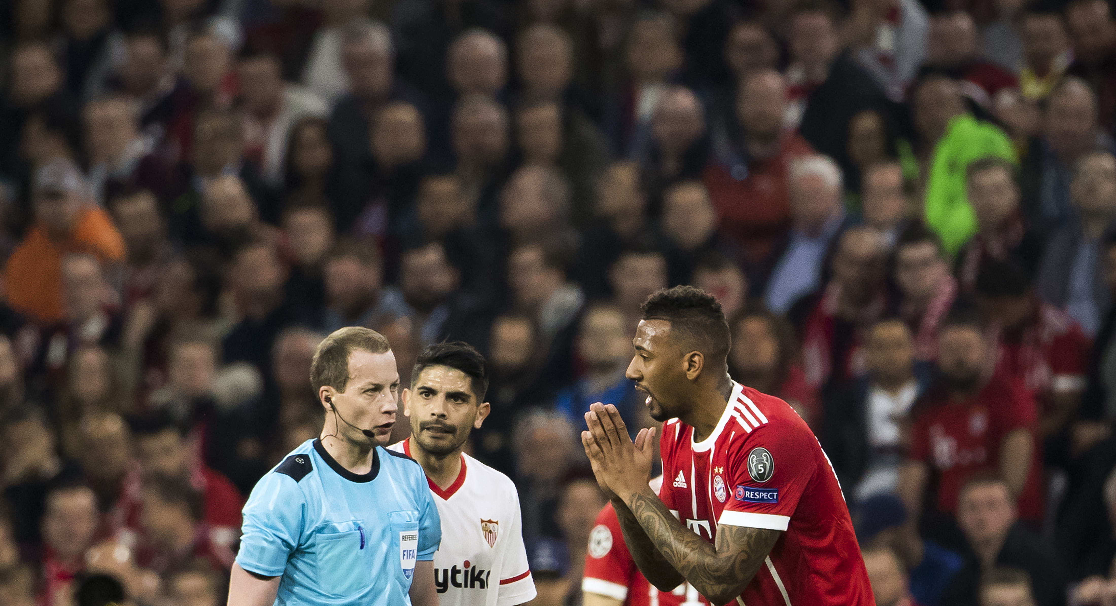 Germany's defender Jerome Boateng (R) pleads with Scottish referee William Collum during the UEFA Champions League quarter-final second leg football match between Bayern Munich and Sevilla FC on April 11, 2018 in Munich, southern Germany. / AFP PHOTO / Odd ANDERSEN        (Photo credit should read ODD ANDERSEN/AFP/Getty Images)