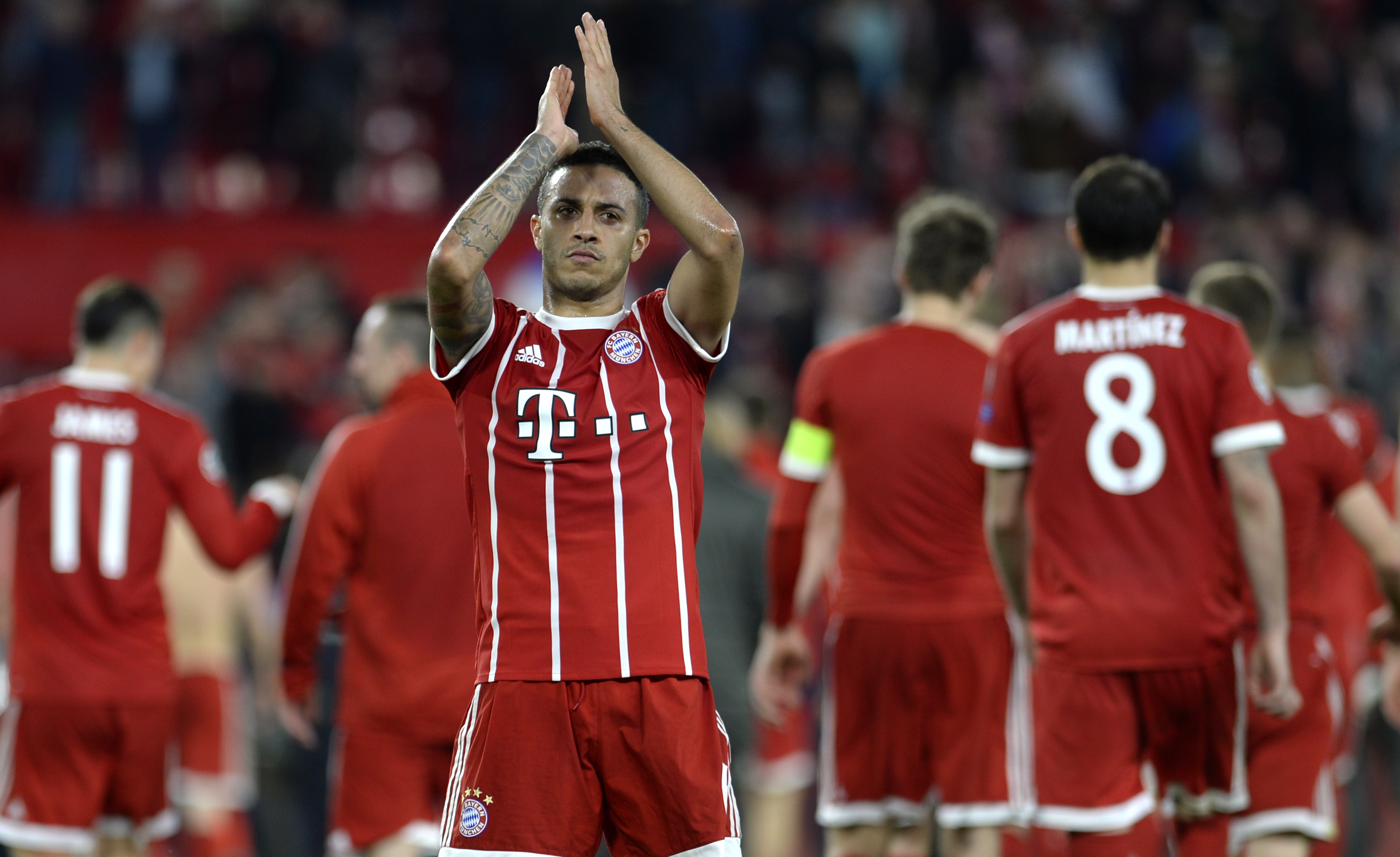 Bayern Munich's Spanish midfielder Thiago Alcantara applauds at the end of the UEFA Champions League quarter-final first leg football match between Sevilla FC and Bayern Munich at the Ramon Sanchez Pizjuan Stadium in Sevilla on April 3, 2018. / AFP PHOTO / CRISTINA QUICLER        (Photo credit should read CRISTINA QUICLER/AFP/Getty Images)