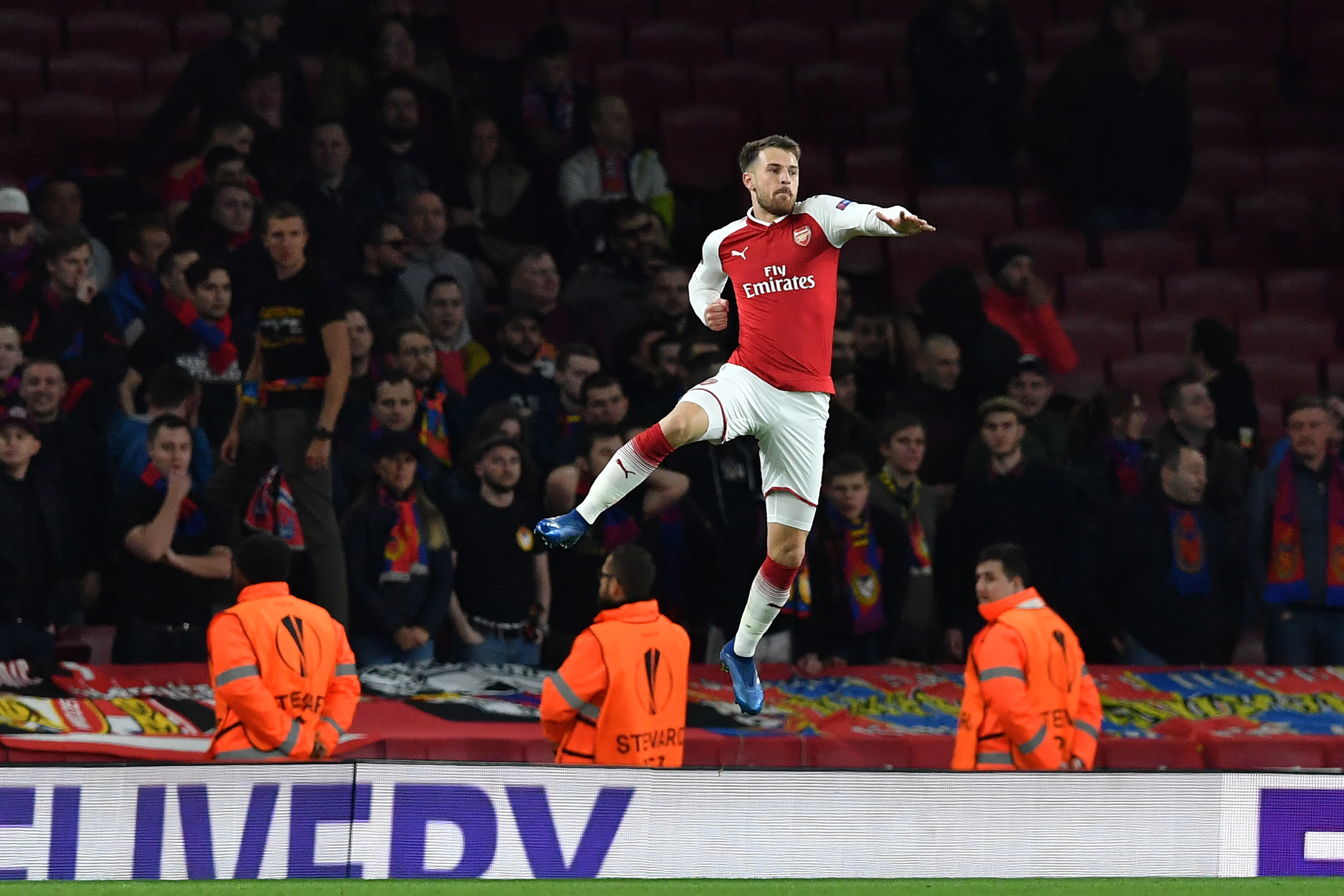 Arsenal's Welsh midfielder Aaron Ramsey celebrates after scoring their third goal during the UEFA Europa League first leg quarter-final football match between Arsenal and CSKA Moscow at the Emirates Stadium in London on April 5, 2018.  / AFP PHOTO / Ben STANSALL        (Photo credit should read BEN STANSALL/AFP/Getty Images)