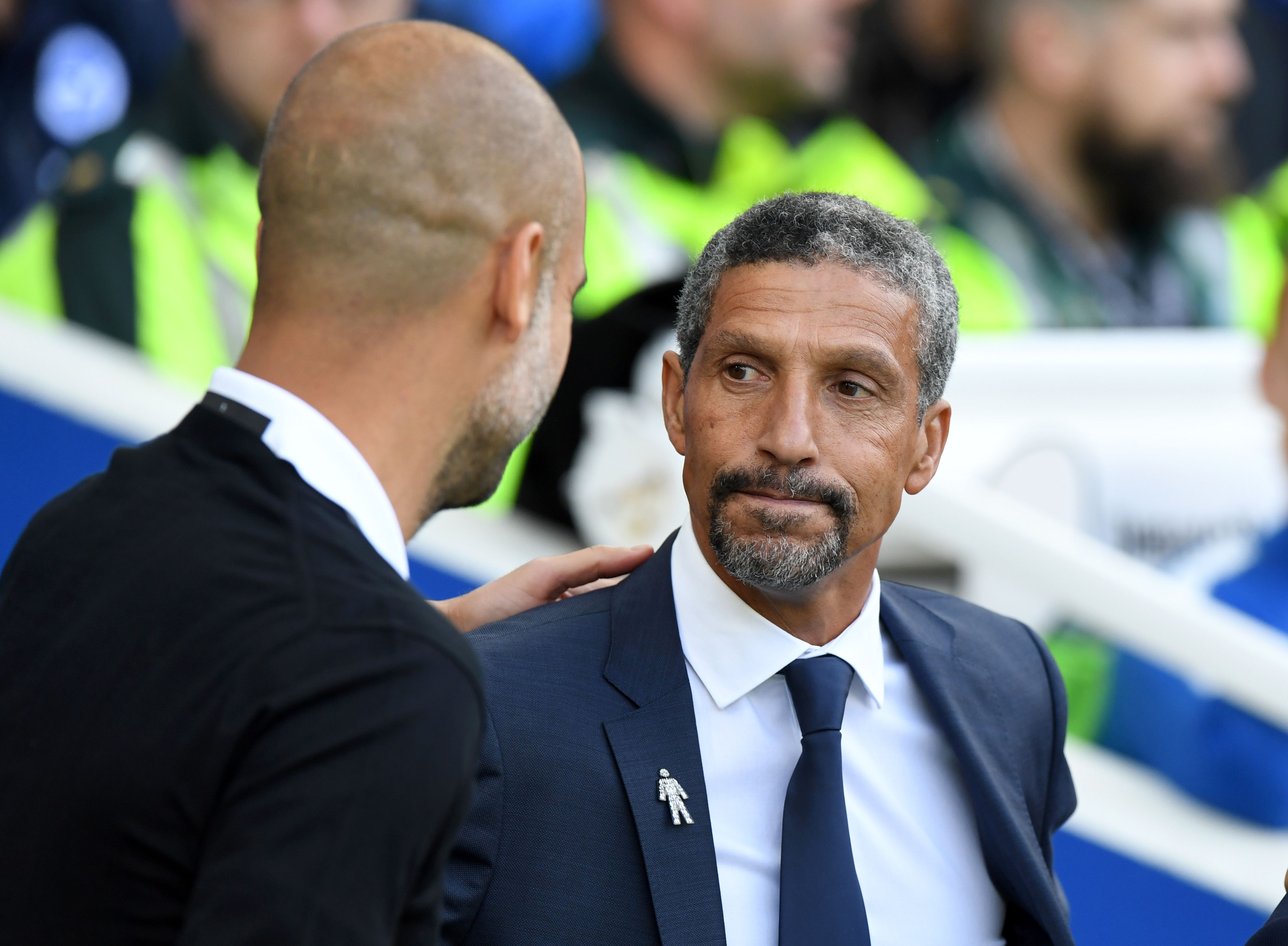 Brighton's Irish manager Chris Hughton (R) greets Manchester City's Spanish manager Pep Guardiola ahead of the English Premier League football match between Brighton and Hove Albion and Manchester City at the American Express Community Stadium in Brighton, southern England on August 12, 2017. / AFP PHOTO / CHRIS J RATCLIFFE / RESTRICTED TO EDITORIAL USE. No use with unauthorized audio, video, data, fixture lists, club/league logos or 'live' services. Online in-match use limited to 75 images, no video emulation. No use in betting, games or single club/league/player publications.  /         (Photo credit should read CHRIS J RATCLIFFE/AFP/Getty Images)
