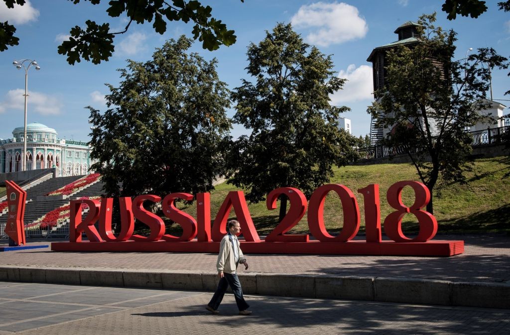 A man walks past a giant sign reading 'Russia 2018' in downtown Yekaterinburg, on August 19, 2017. The city of Yekaterinburg will host several games of the FIFA World Cup 2018. / AFP PHOTO / Mladen ANTONOV (Photo credit should read MLADEN ANTONOV/AFP/Getty Images)